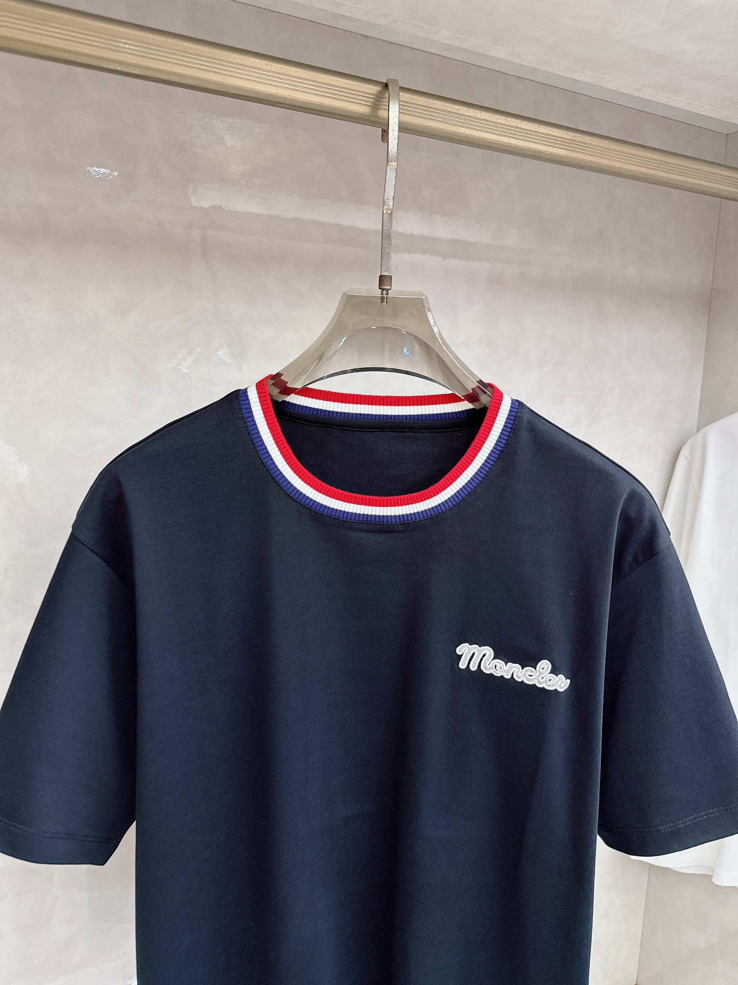 蒙口 2026春夏新款 圆领短袖 领部的采用针织红白蓝设计 很有亮点 上身时尚而有细节 胸口与肩部铭牌刺