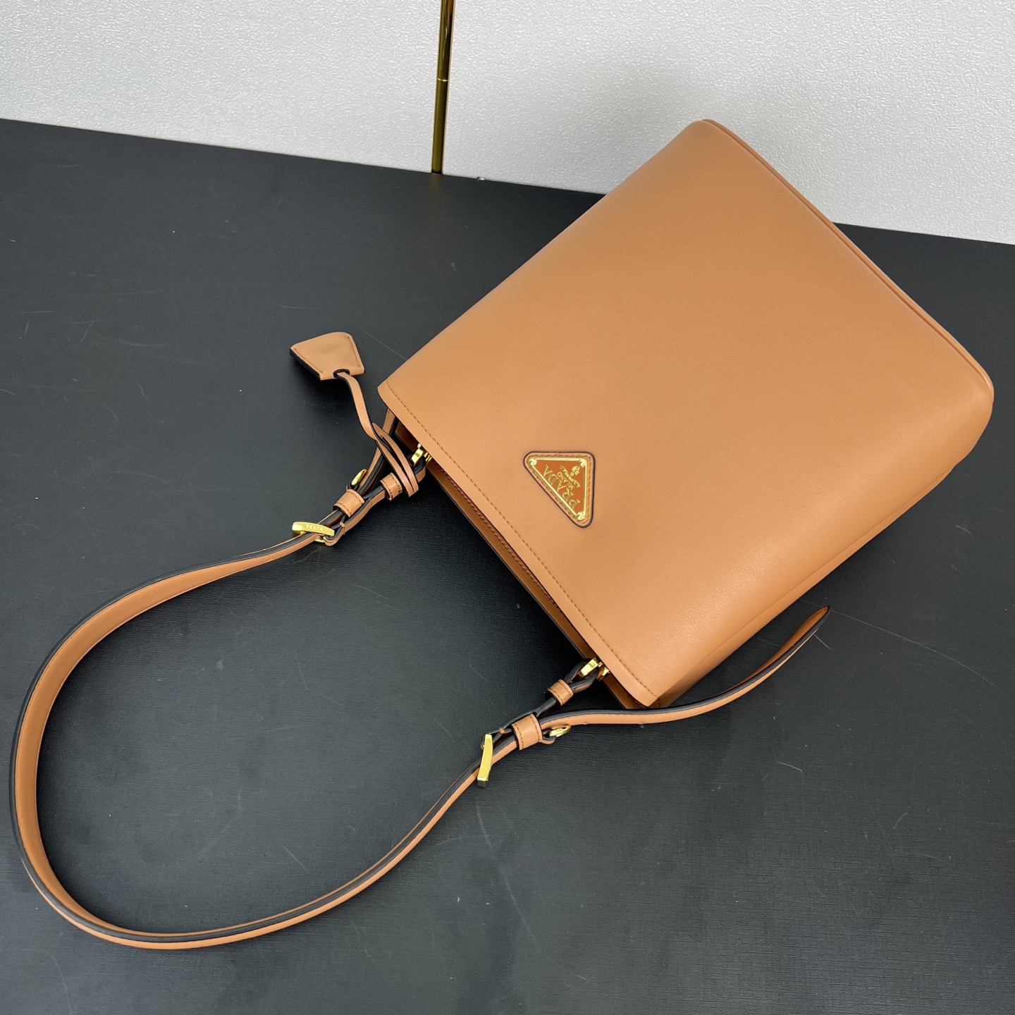 🎉新品🎉1BE080水桶包🎉P这款皮革手袋拥有柔和线条与精美设计，凸显经典格调与手工细节。实用百搭，饰有