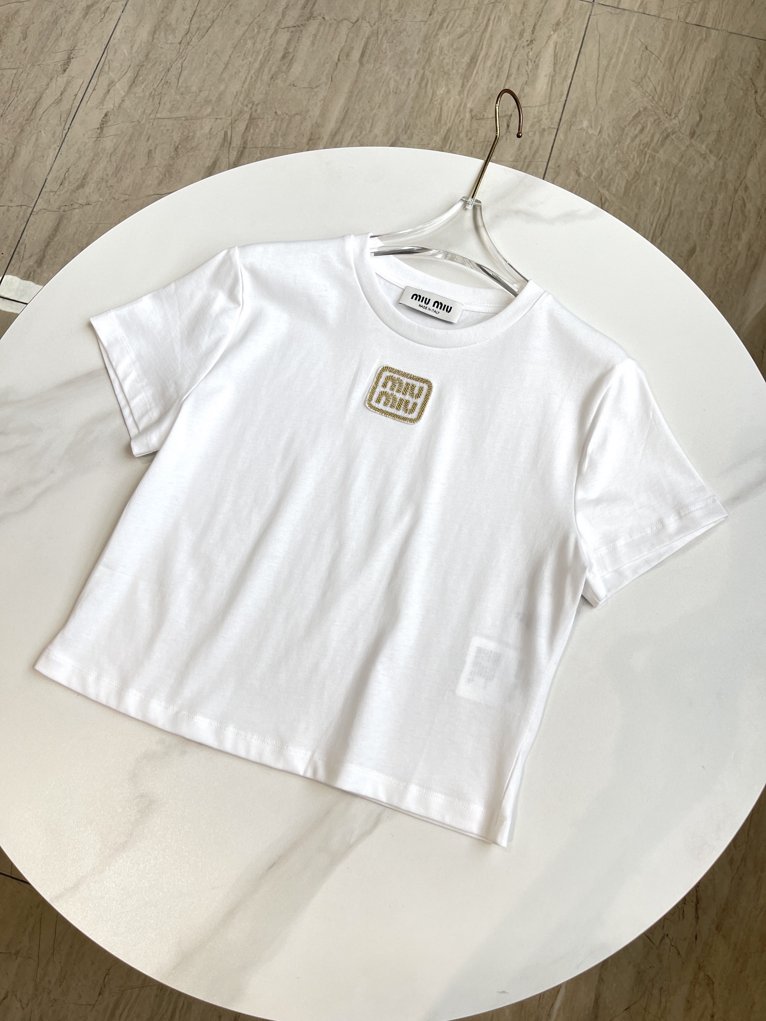 这款平纹针织棉质T恤采用简洁流畅的线条设计，饰有引人注目的Miu Miu徽标，彰显经典格调