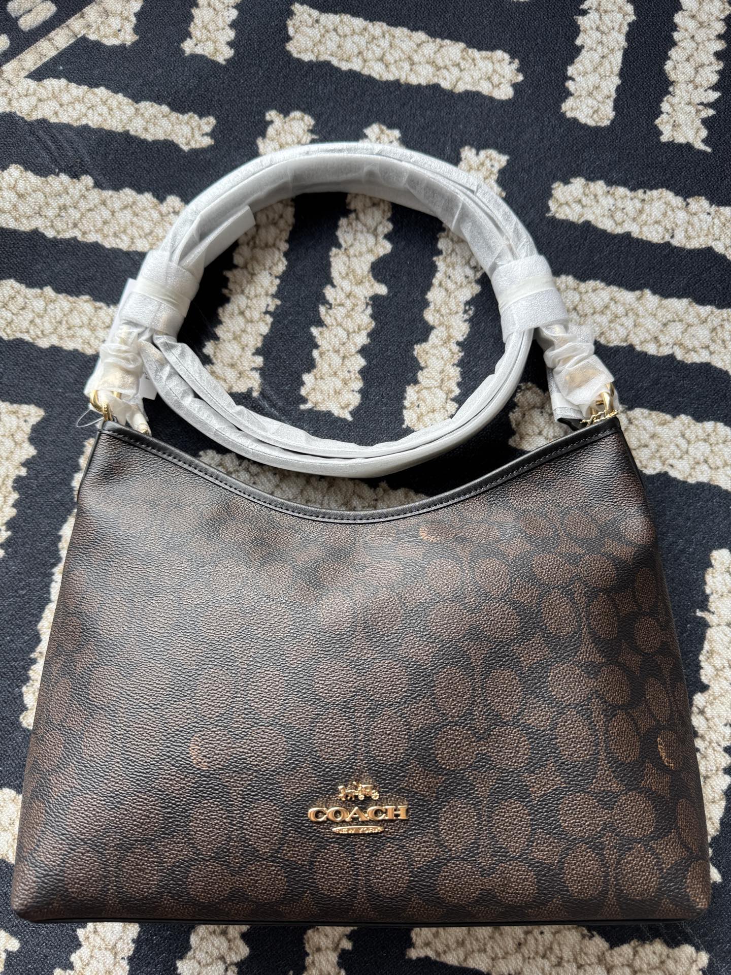 纯原Coach蔻驰 CV975 laurel
黑咖系列流浪包 实拍细节图来一组
天花板品质，随便拿去跟市场的顶级代购级对比，配原厂五金，原厂故事牌，鉴定点都对，是不是好东西自己拿我们的细节图去跟别人的对比，怼细节去比就行
单肩斜挎包。
🔥的一塌糊涂，新款签名涂层老花料配头层牛皮材质，配长短两根肩带，手拎单肩斜挎都可以，慵懒造型，开口弧形设计，容量超大，颜值与实用性并存，四季通用，百搭各种风格，简直是日常出行的神器。
尺寸：28×18×11cm