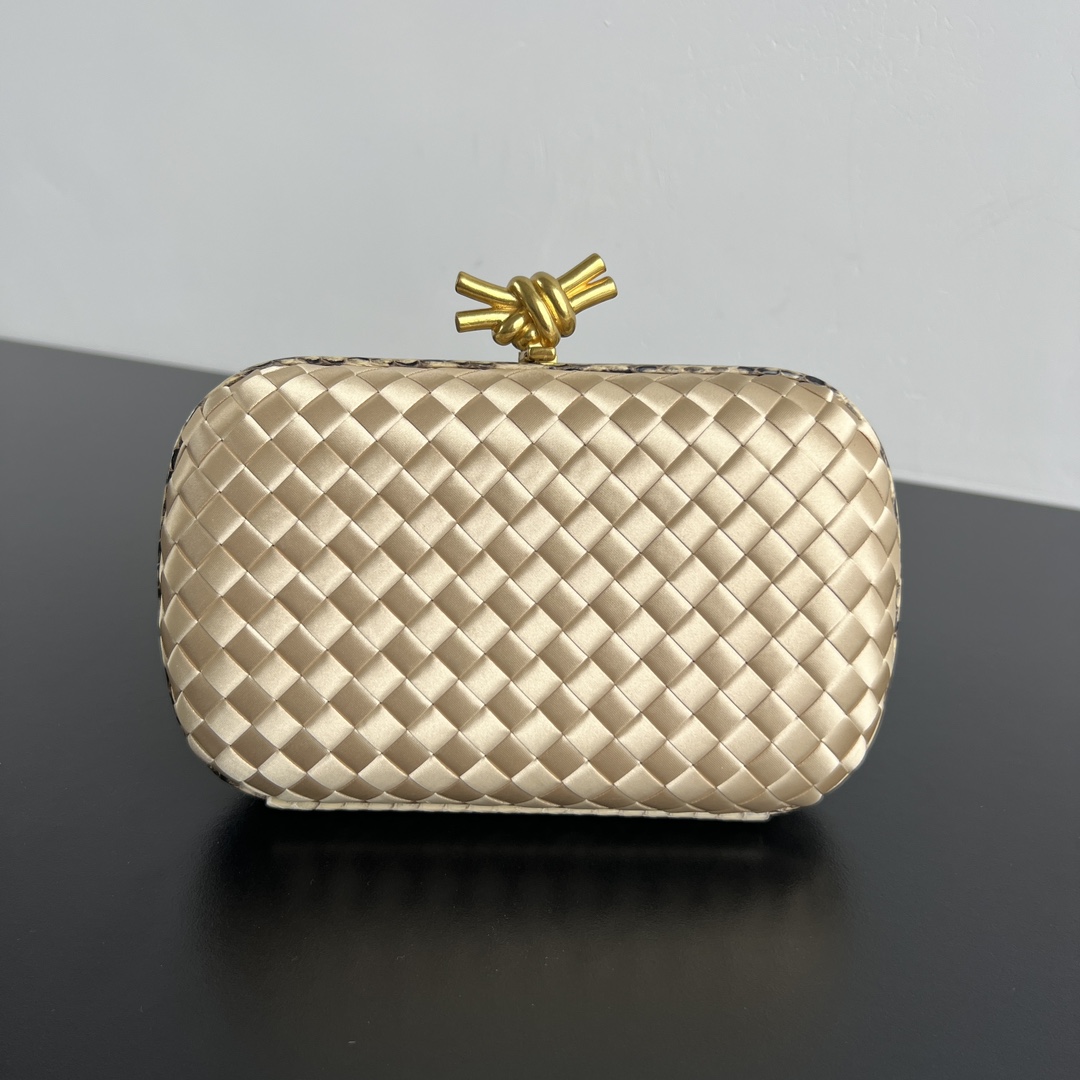 Knot woven evening bag with snakeskin trim and knot clasp