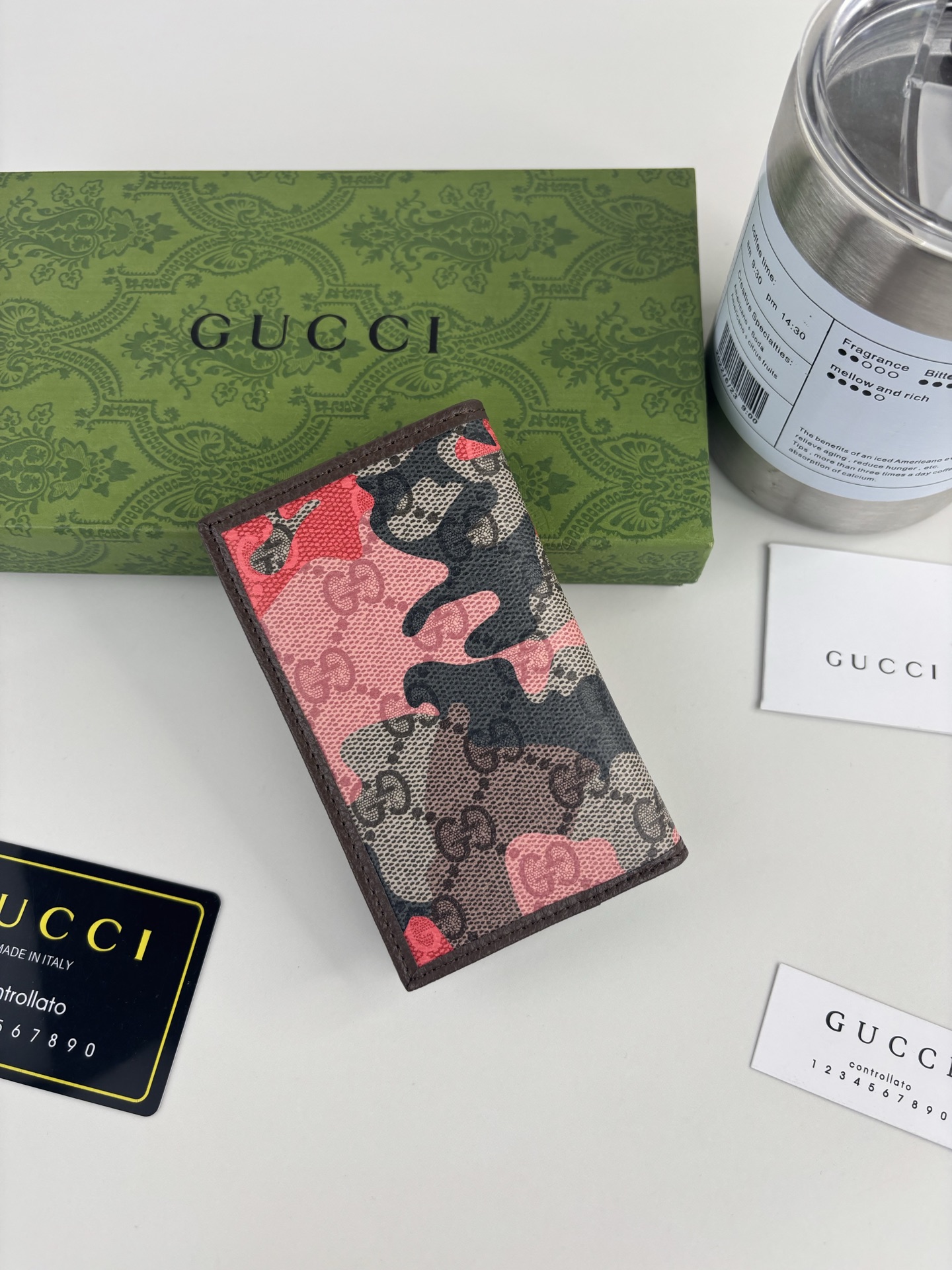 GUCCl生动迷彩结合别致配色，焕新演绎经典GG图案。这款长款卡片夹以大理石纹GG字母图案涂层织物打造，匠心融蕴双G细节