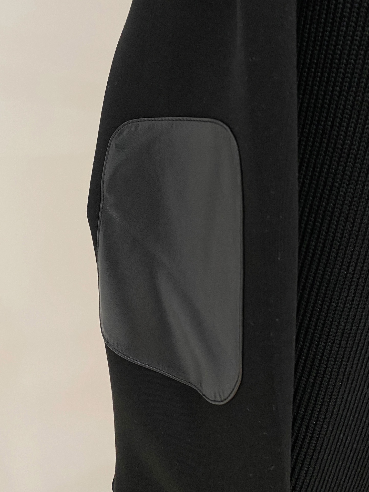 。普拉达 2025秋冬 羊毛混纺套头针织卫衣 几何拼皮的口袋设计 很有亮点，标志字母纽扣 细节上凸显质感