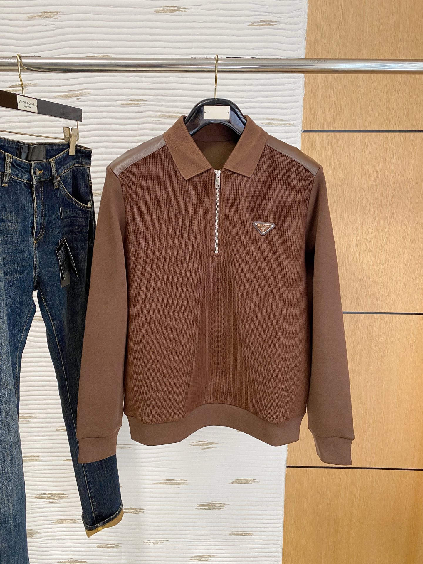 。普拉达 2025秋冬  羊毛混纺套头针织卫衣  几何拼皮的口袋设计 很有亮点，标志字母纽扣 细节上凸显