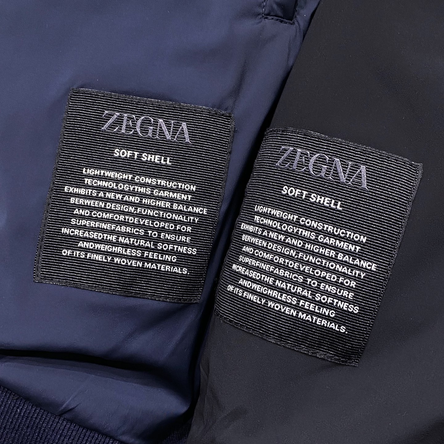 ZEGNA25FW秋冬新款针织面料拼接立领羽绒夹克，LL男士拼皮拉链门襟立体浮雕徽章羽绒服外套！贸易公司