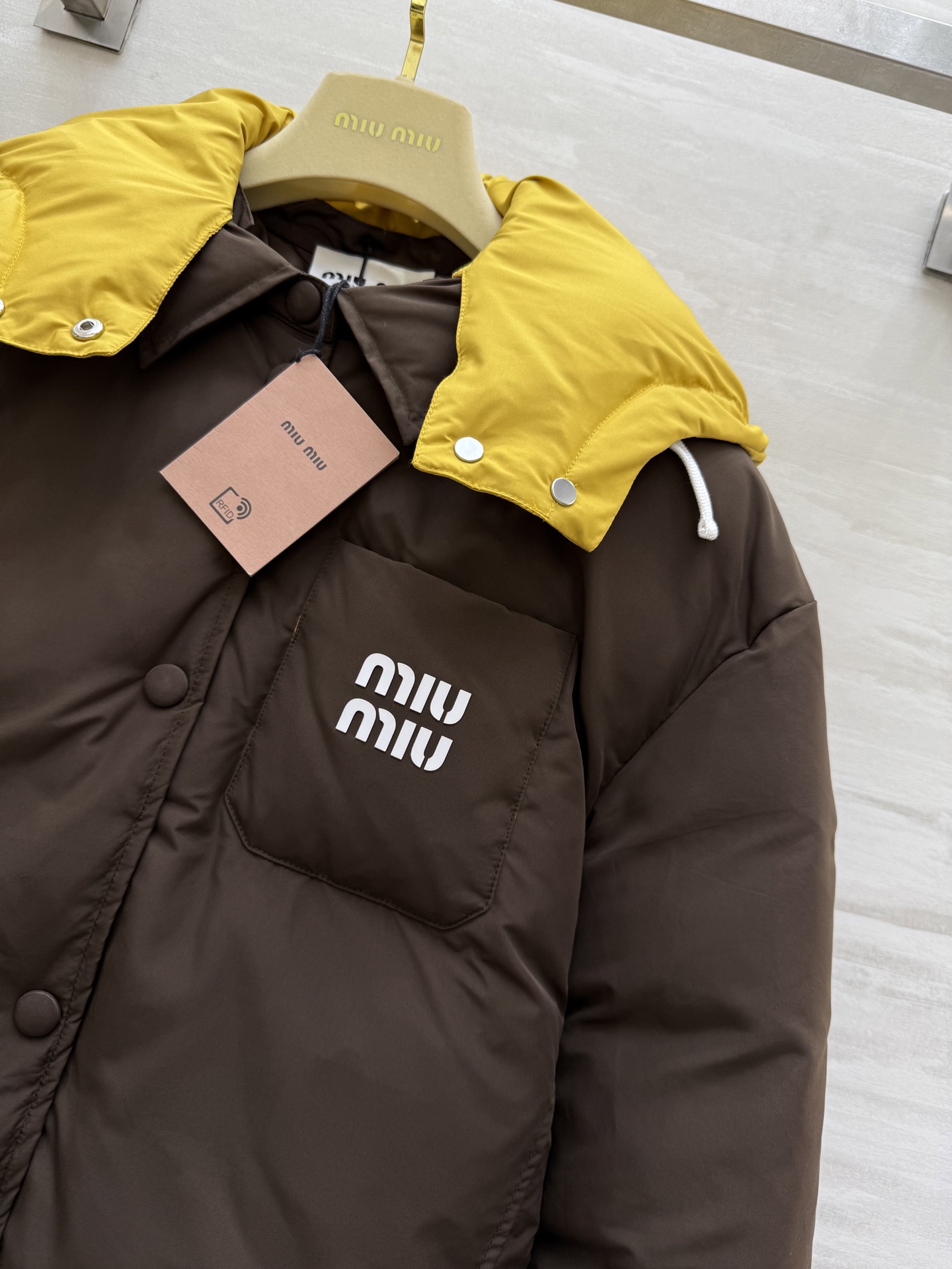 #Miumiu²⁵秋冬新款 假两件拼色面包羽绒服 深棕主调自带酷感 亮黄连帽撞色超吸睛 打破冬日沉闷 翻