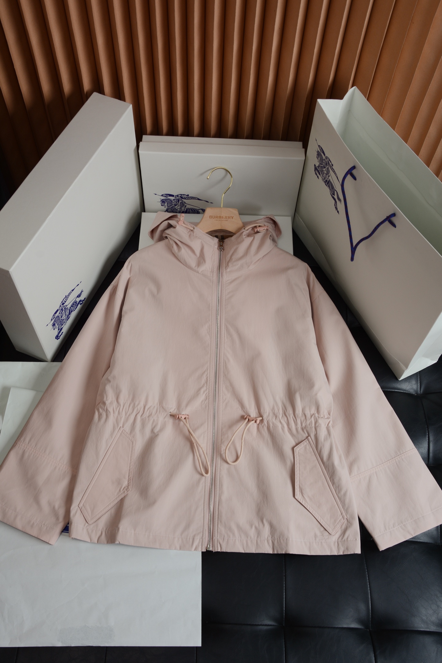 NO:786939,Hardware details · Low-key sophistication  The hardware accessories of the entire jacket have the right balance of practicality and brand texture. The main zipper uses a brand-customized metal zipper, which is smooth and not stuck. The zipper puller has the brand logo. The matte metal texture matches the soft tones of the body very well. It is low-key and unobtrusive, and the damping feeling of the pull is also very delicate. The drawstring waistband and the brim of the hat are adjusted in the same color drawstring, and matched with a metal rope buckle, you can easily adjust the tightness and create a comfortable fit.  It can create different dressing effects, and can echo the overall style in details, which is practical and exquisite. The inner details can be seen by opening the hood and seeing the iconic classic plaid lining, which is one of the most recognizable elements of BURBERRY. The contrasting plaid pattern of light carmine red and military green forms a low-key contrast with the solid color body. When the zipper is unzipped or worn open, the lining is inadvertently exposed, which instantly highlights the brand style.  Fabric texture · Comfortable and functional  The jacket is made of cotton blended fabric, which combines the neatness and stiffness of a windbreaker with the comfort of daily wear. The fabric has been treated with a special process and has a delicate matte texture. It feels soft and skin-friendly, but has a stiffness that prevents the upper body from being slumped and shapeless. It is also windproof and water-repellent, making it stress-free to deal with changing weather. The fabric is resistant to  It has excellent wrinkle resistance, is not prone to wrinkles in daily wear, and is easy to take care of. It comes in two colors: light carmine red and army green. The fabric is evenly colored, has a high-end texture, and has no cheap reflective feel. The upper body comes with a soft high-end filter. The plaid fabric inside is skin-friendly and breathable, and there is no discomfort when worn next to the skin. It will not be stuffy even when worn alone in spring and autumn.  Style tailoring · Relaxed silhouette that hides flesh and makes you look slimmer  The design of the short hooded windbreaker perfectly balances leisure and elegance, and is very friendly to all body types. The overall shape is a slightly loose straight silhouette, neither tight nor oversized. The upper body is neat and does not weigh down the body, and is comfortable for the waist, abdomen and hands.  The arms are extremely tolerant and can easily hide the little flesh. The drawstring design on the waist is the finishing touch of the whole piece. The elasticity can be adjusted freely, which can not only create a high waistline, optimize the body proportions, but also create a lazy and casual atmosphere. Between retracting and retracting,  You can switch between different dressing styles. The hooded design has casual attributes. The hat shape is three-dimensional and not soft. It is equipped with an adjustable drawstring, which can prevent wind and modify the face shape. The hem design, which is short in the front and long in the back, can well modify the crotch line. It can be easily matched with jeans, sports pants, and skirts, and can easily create an effortless British relaxed feeling. Burberry - Clothing, burberry, versace, skirts, jeans, jackets  & coats,hats,19860909五金细节 · 低调的精致感 整件外套的五金配件,把实用性和品牌质感拿捏得恰到好处.主拉链采用品牌定制的金属拉链,顺滑不卡顿,拉链头带有品牌标识,哑光金属质感和衣身柔和的色调适配度极高,低调不张扬,拉合的阻尼感也十分细腻.调节抽绳腰头和帽檐的同色系抽绳,搭配金属绳扣,既能轻松调整松紧度,打造不同的穿搭效果,又能在细节处呼应整体风格,实用又不失精致.内里细节翻开帽子就能看到标志性的经典格纹内衬,这是BURBERRY最具辨识度的元素之一,浅胭脂红与军绿的撞色格纹,和纯色衣身形成了低调的反差感,拉开拉链或敞开穿时,不经意露出的内里,瞬间点明品牌格调. 面料质感 · 舒适与机能兼具 外套采用棉质混纺面料打造,兼顾了风衣的利落挺括和日常穿着的舒适感.面料经过特殊工艺处理,自带细腻的哑光肌理感,触感柔软亲肤,却又自带挺括度,上身不会软塌无形,同时具备防风防泼水的特性,应对多变天气毫无压力.面料抗皱性优秀,日常穿着不易起皱,打理起来也很方便,浅胭脂红和军绿色两种配色,面料着色均匀,质感高级,没有廉价的反光感,上身自带柔和的高级滤镜.内里的格纹面料亲肤透气,贴肤穿着也毫无不适感,即使在春秋季单穿也不会闷热. 版型剪裁 · 藏肉显瘦的松弛廓形 短款连帽风衣的版型设计,完美平衡了休闲与优雅,对各种身材都十分友好.整体是微宽松直筒廓形,不紧绷也不过于oversize,上身利落不压个子,对腰腹和手臂的包容度极高,能轻松藏住小肉肉.腰部的抽绳设计是整件的点睛之笔,可自由调节松紧,既能打造出高腰线,优化身材比例,也能营造出慵懒随性的氛围感,收放之间,就能切换不同的穿搭风格.连帽的设计自带休闲属性,帽型立体不软塌,搭配可调节抽绳,既能防风又能修饰脸型,前短后长的衣摆设计,能很好地修饰胯部线条,搭配牛仔裤、运动裤、半身裙都能轻松驾驭,轻松打造不费力的英伦松弛感.,博柏利-服装,burberry,versace,skirts,jeans,jackets & coats,hats,,Women's clothing