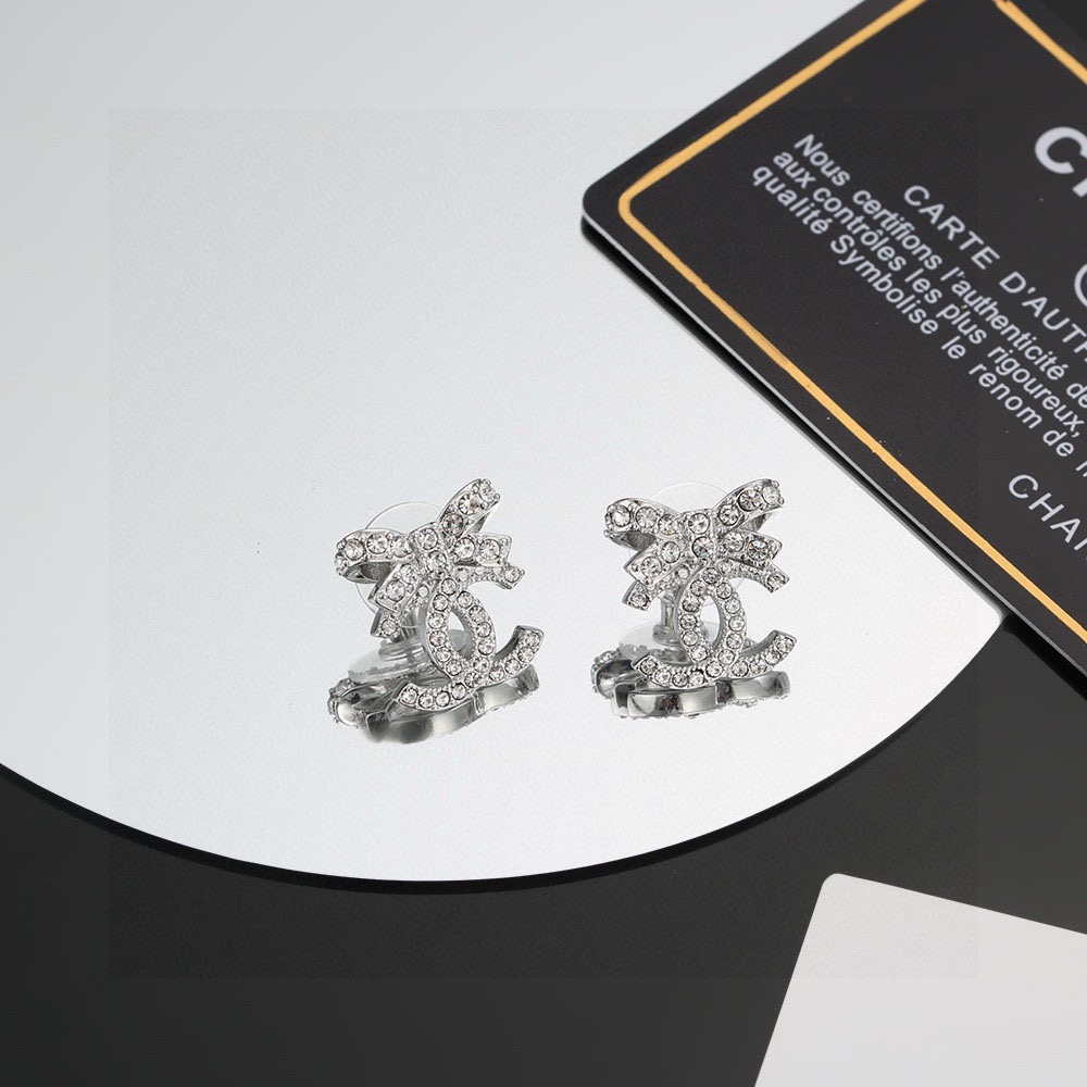 chanel silver crystal bow cc stud earrings