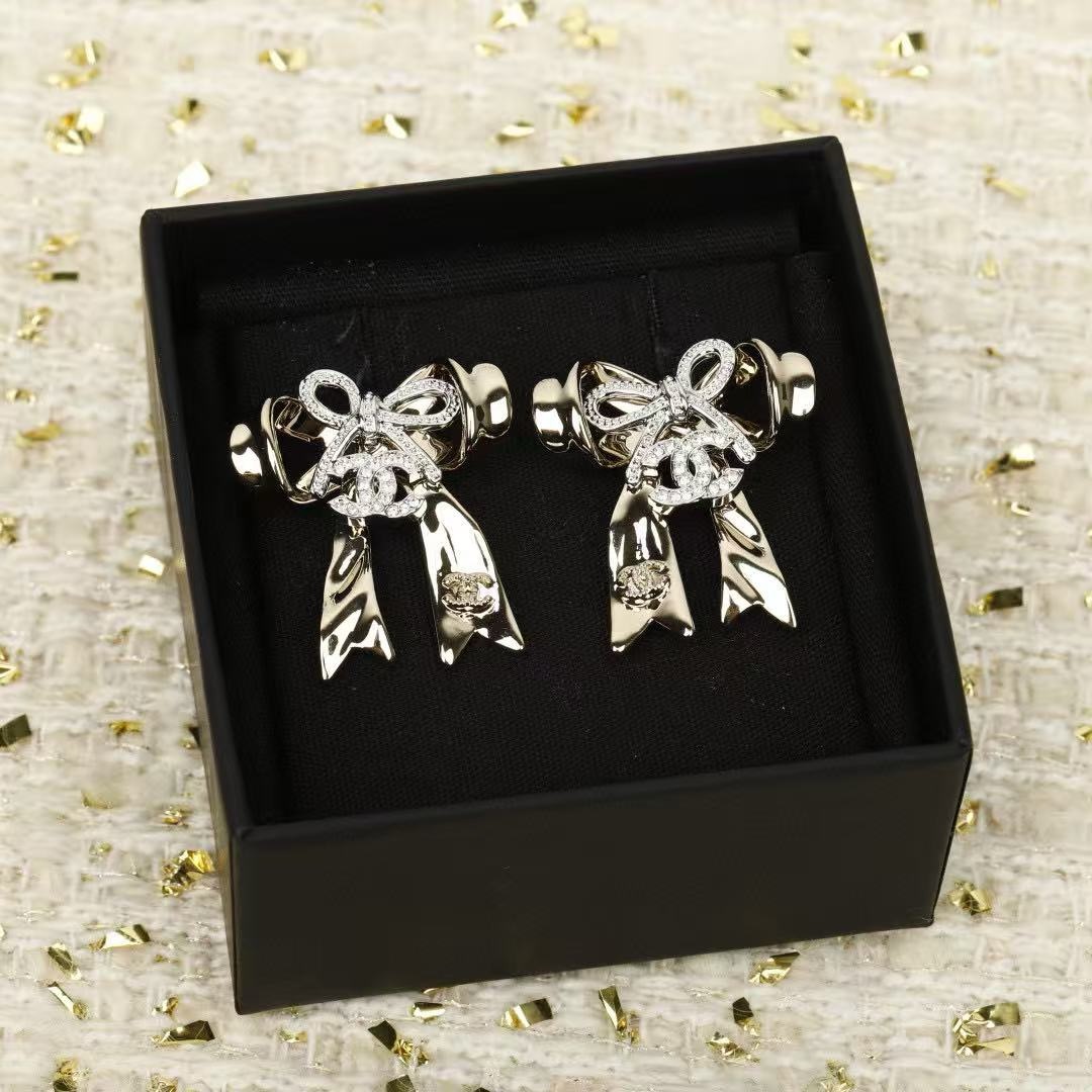 chanel silver crystal cc bow drop earrings