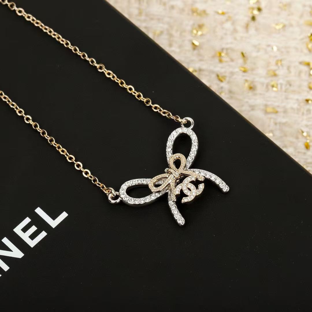 Chanel CC Bow Crystal Pendant Necklace necklace Two-tone gold and silver toned metal with clear crystal accents 42cm with 5cm extender