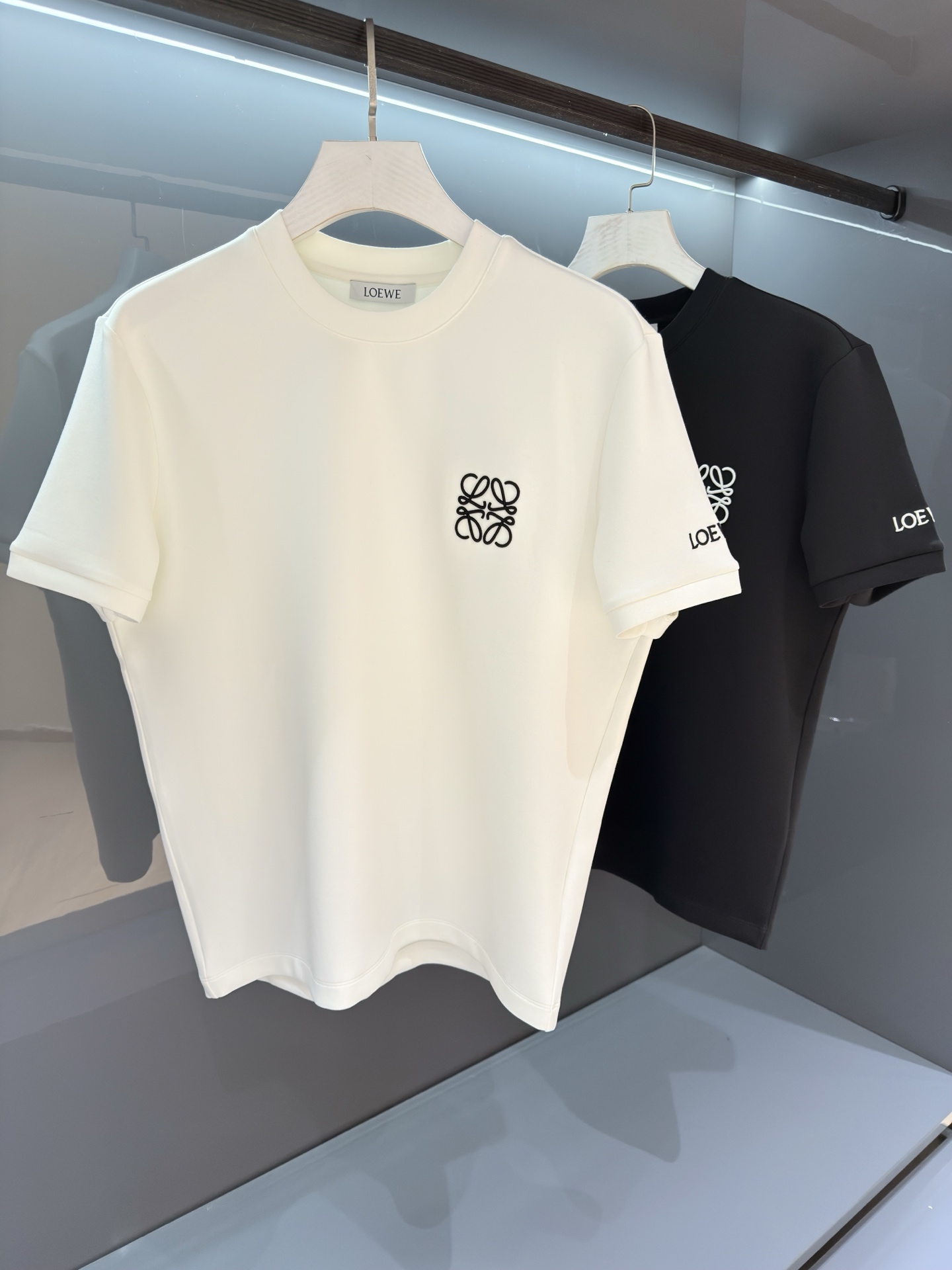 NO:597954,[New product] Autumn and winter bottoming short-sleeved T-shirt. A new way to interpret exquisite craftsmanship, luxury meets vibrant lines. 2025SS new autumn and winter product Lo*we couple's embroidered logo round neck short-sleeved T-shirt. The latest color matching has the latest fashion! The unique color charm infinitely extends the unique charm of trendy fashion.  Worsted island cotton supplied by customers is characterized by a more delicate woven cotton surface without any scattered flaws, breathable and comfortable to wear, and a soft and delicate feel. The ribbed collar is detailed and the background color is spray-painted, showing a three-dimensional fashion sense and highlighting a new style that stands out... Color White/Black Size S/M/L/XL/2XL  S Shoulder width 43 Bust 98 Length 67 Sleeve length 22, T-shirt, tees, t-shirt, alexander wang19860909【新品】秋冬打底短袖T 全新方式演绎精湛工艺,奢华的邂逅充满活力的线条 2025SS 秋冬新品 Lo*we 情侣款刺绣logo圆领短袖T恤 最新配色拥有最新的时尚!独特的色彩魅力无限延伸了潮流时装的别样韵味. 客供精纺海岛棉,特点在于织造棉面更为细腻无任何零散瑕疵,着身透气舒适,手感柔软细腻. 罗纹领圈工装细致,底色采用喷绘式设计,彰显立体时尚感,突出出镜出彩的全新风格… 颜色白色/黑色 尺码S/M/L/XL/2XL S肩宽43胸围98衣长67袖长22,,T-shirt,tees，t-shirt,alexander wang,Men's clothing