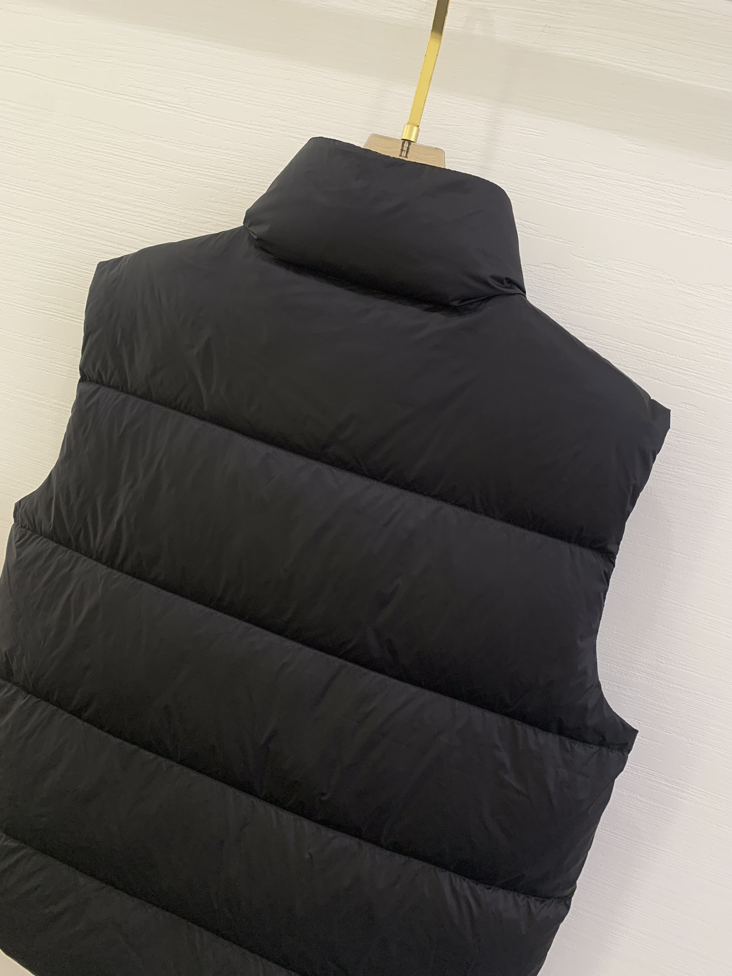 Prada三角标立领 羽绒马甲 这款采用国内客供顶级的尼龙织物面料面料表面的光泽感极强色泽油亮，尼龙织物