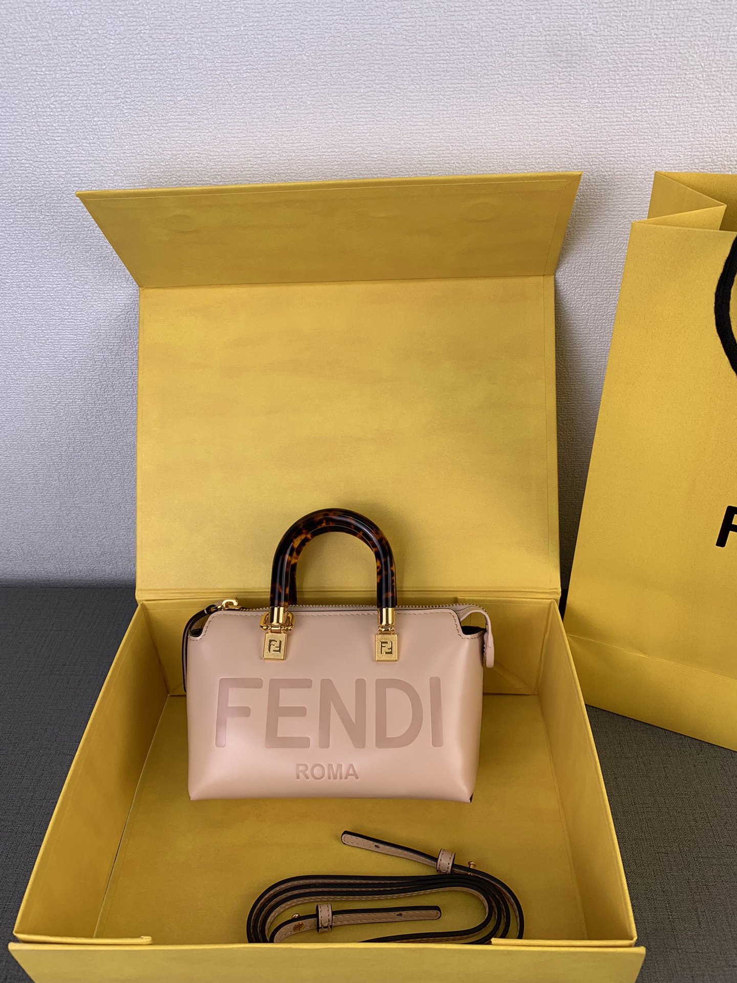 In stock ✔️ Mini "By The Way"  
Note: Chain ⛓️ sold separately  
FENDI follows the recent mini bag trend  
Light pink calfskin with tortoiseshell handle ✨✨✨  
This year's trendiest color ☘️☘️  
Compact yet spacious,  
Detachable shoulder strap, can be hand-carried or crossbody  
Super stylish ❤️  
Style No. 88L122  
Size: 20 x 12 x 9 cm image 1