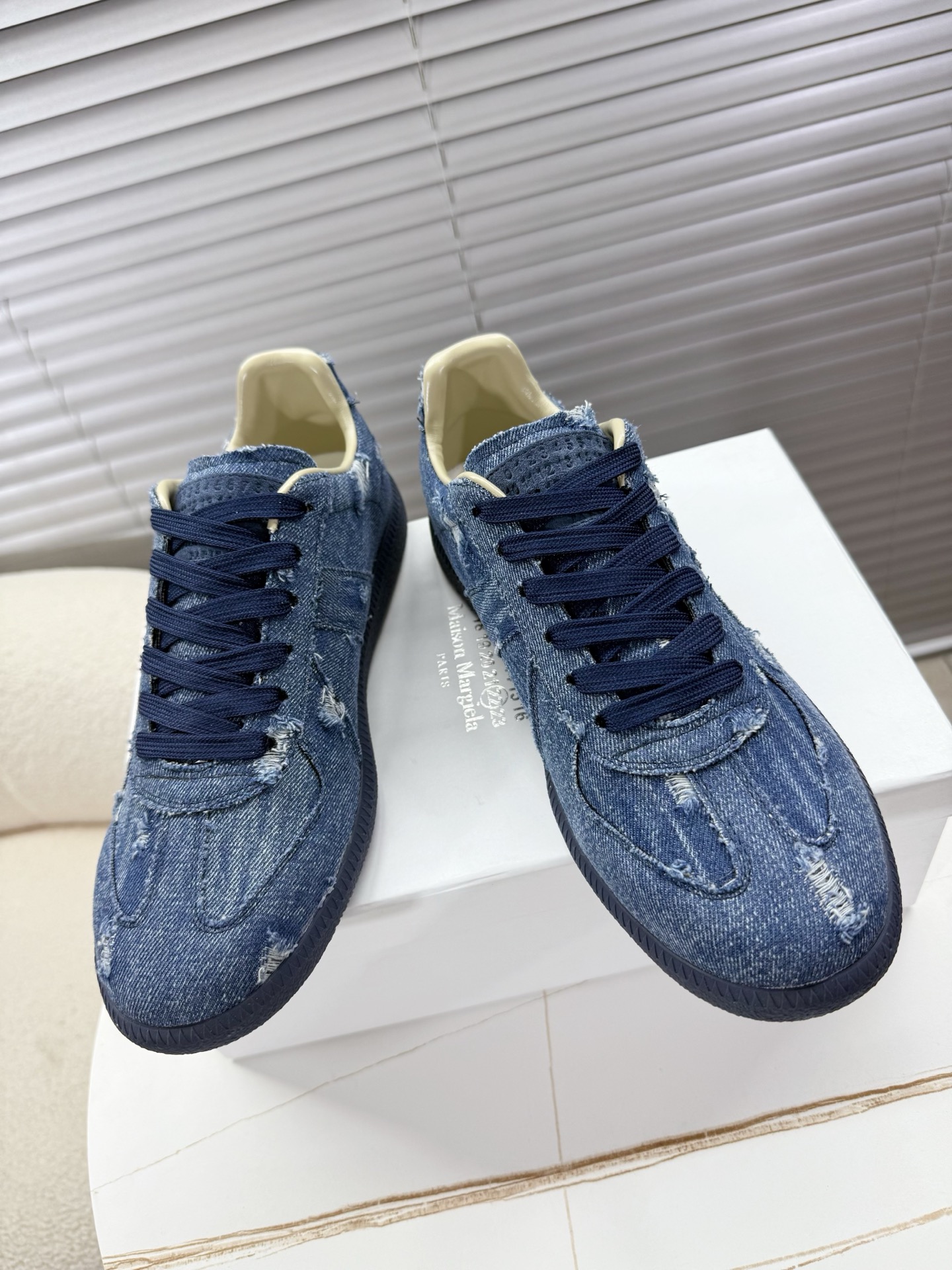 Maison Margiela releases updated MM6 couples’ shoes, Agam sneakers in sauerkraut skin/silver velvet for adults.
