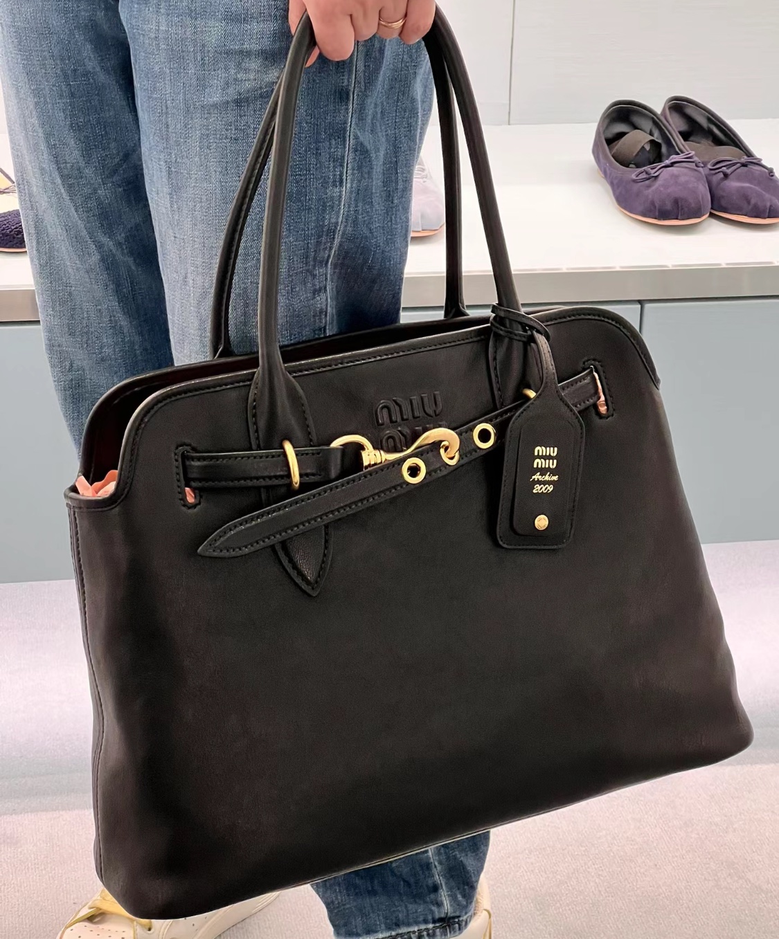 A classic tote bag designed with a softly structured silhouette, a - Comprehensive 7