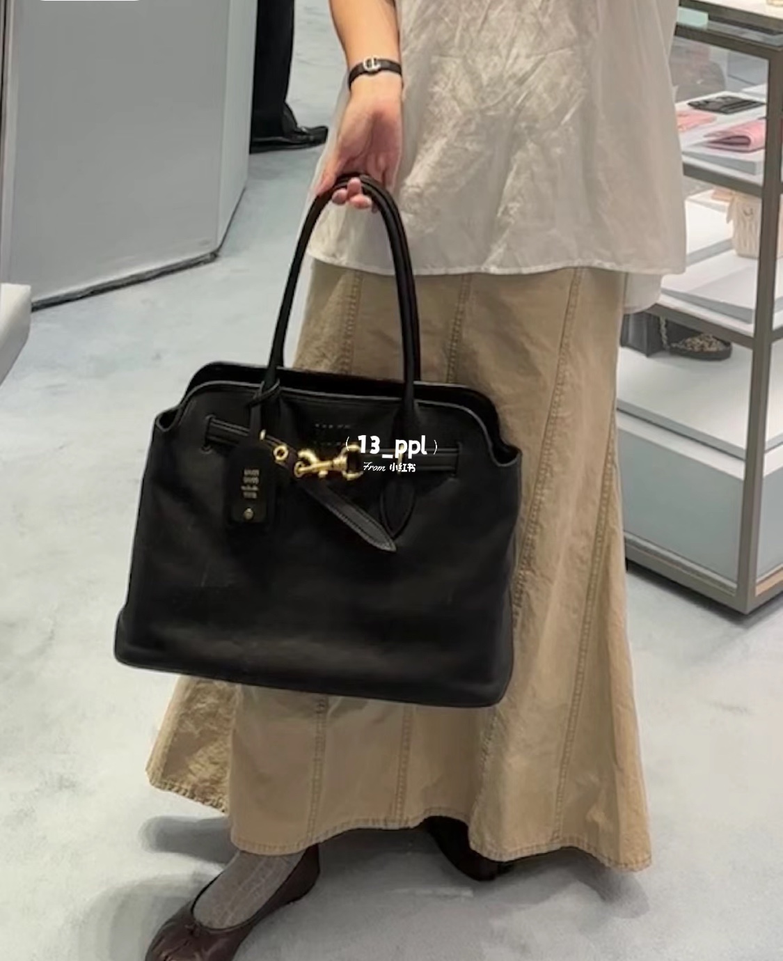 A classic tote bag designed with a softly structured silhouette, a - Comprehensive 9