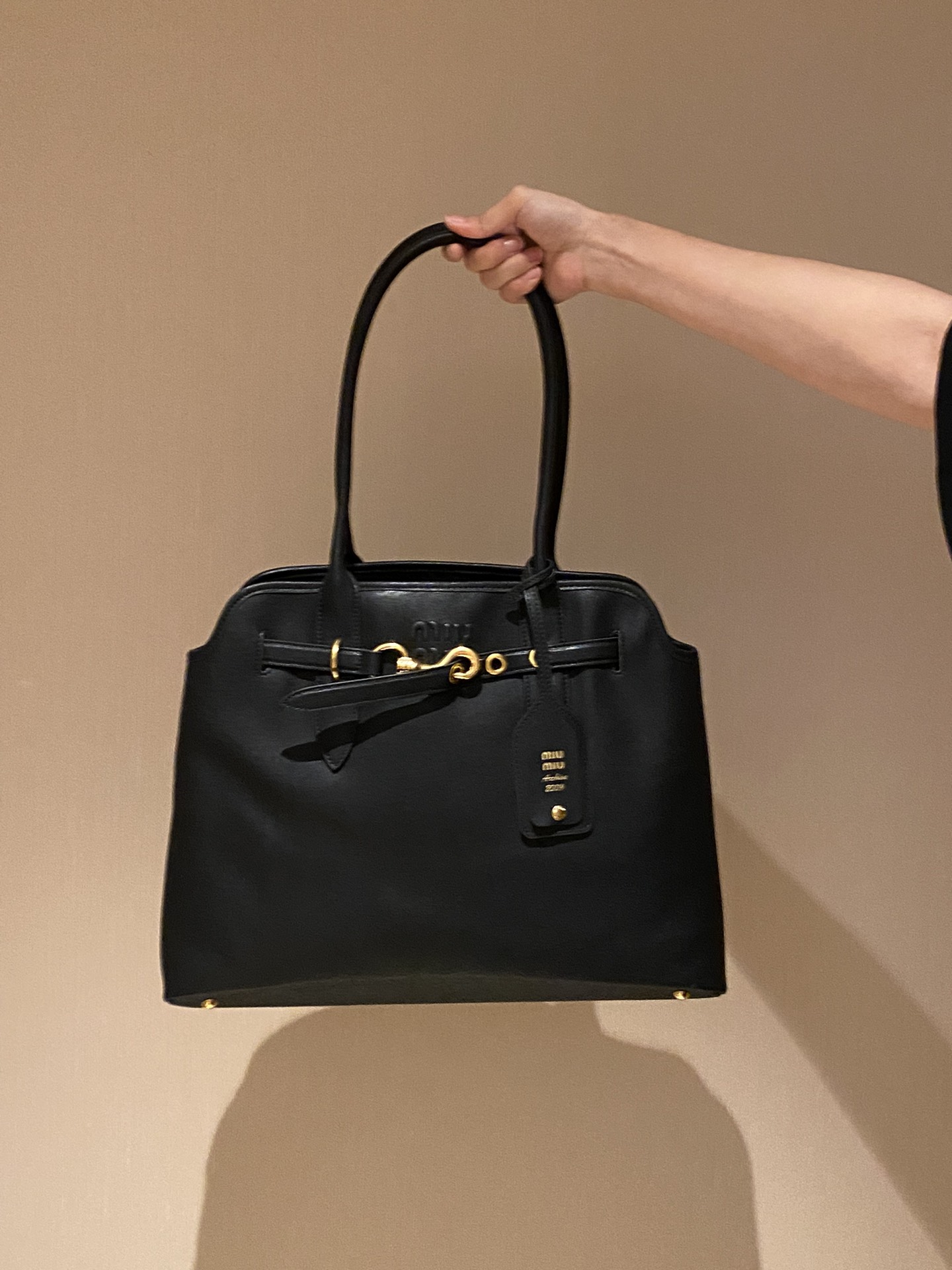 Miu Miu Large Tote Bag featuring an embossed logo on a structured - Comprehensive