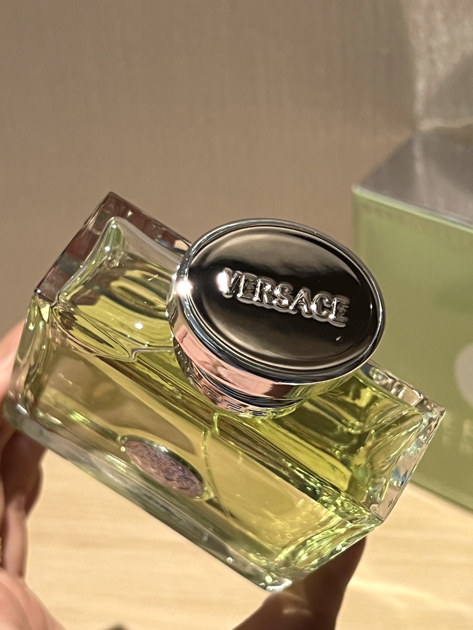 A polished silver-tone Versace logo is centered on the bottle - Comprehensive 5