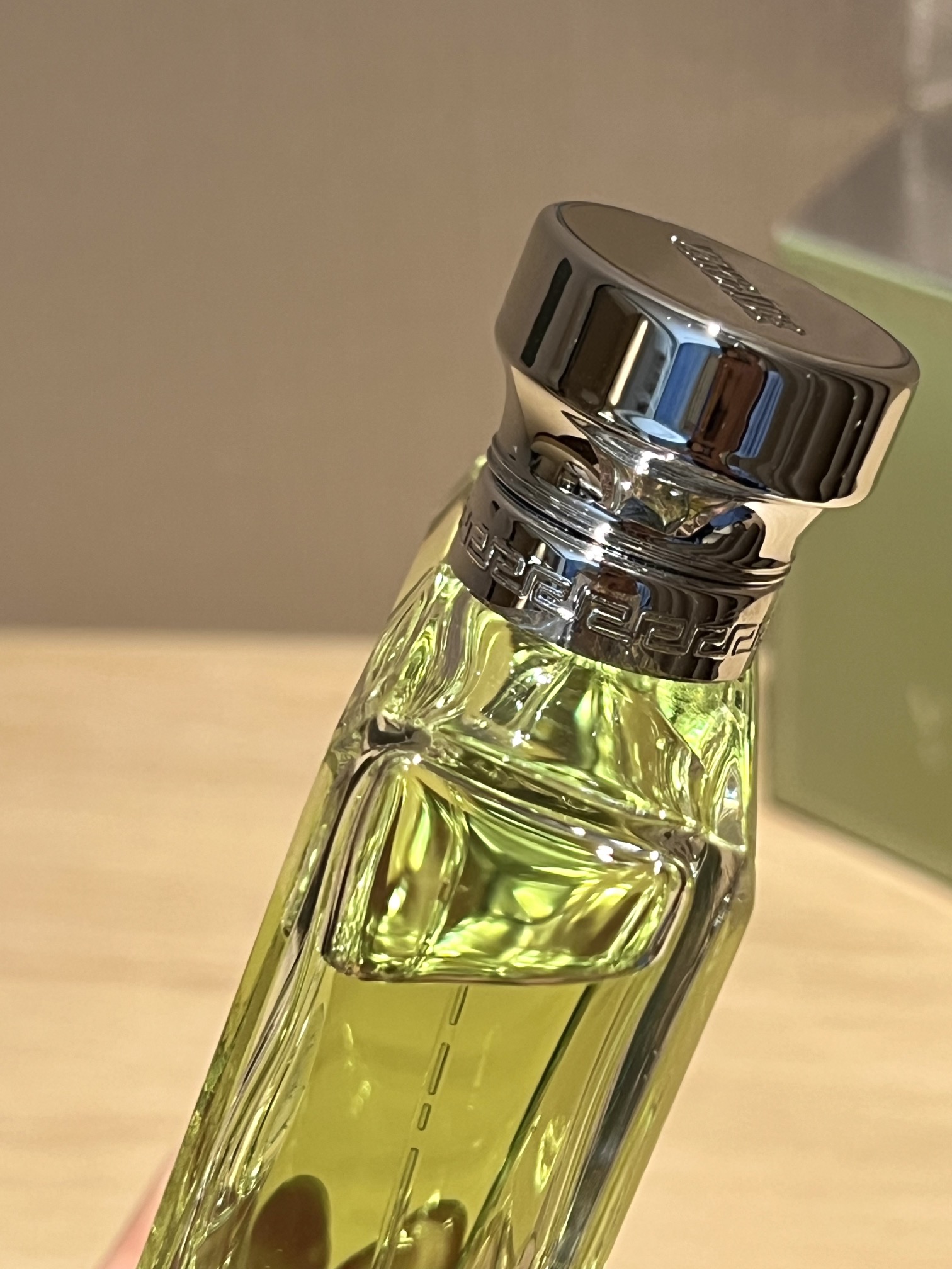 A polished silver-tone Versace logo is centered on the bottle - Comprehensive 4