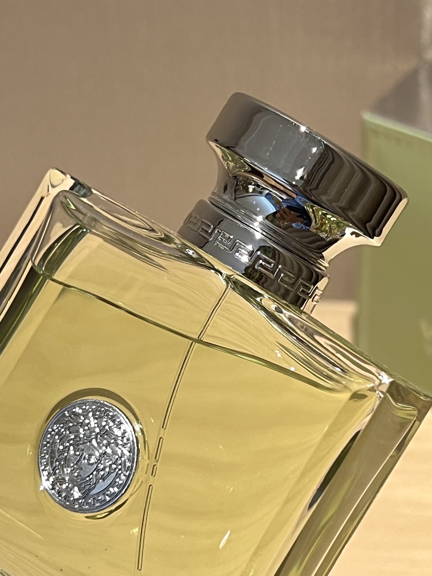 A polished silver-tone Versace logo is centered on the bottle - Comprehensive 2