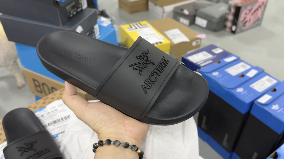 Arc'teryx all-black outdoor slide, shown in the original source video.