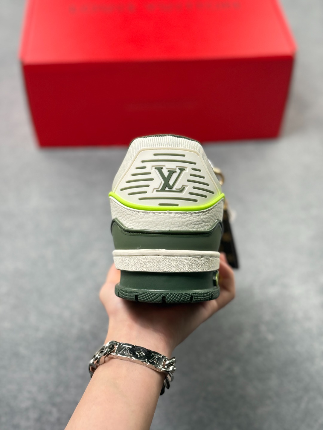 LV TRAINER白灰+荧光绿(中国红限定礼盒版本-钥匙扣丢失扣20元) 26年限定中国红礼盒及全套包装说明书防尘布袋物件,完美楦型,独家开模定制! trainer这个系列是路易威登融合街头潮流与高级时装的标志性之作.在材料选用上,鞋面采用Monogram印花与Monogram压纹粒面牛皮革的搭配,呈现出独特的复古韵味.荔枝纹粒面头层牛革鞋面,触感细腻且富有韧性,自带自然的皮革纹理,彰显高级质感,为鞋子增添了丰富的层次感.鞋垫采用原版超软乳胶材质,新鞋零磨合不磨脚,软乎乎的皮质包裹感超棒,鞋底则采用橡胶材质,刻有经典的Monogram花卉纹路,不仅防滑,还带走缓震效果还极具设计感.做工方面,TRAINER系列板鞋展现了精湛的工艺水准.鞋头采用圆润设计,原版空胶工艺搭配包边工艺,不仅美观,还能有效防踢蹭.鞋舌、侧面和后部饰有LV字母,侧面还有Vuitton标识,均做工精细,彰显品牌身份.鞋身走线工整均匀,看不到任何多余的线头,皮革的拼接处也处理得极为细腻,体现了我们对细节的极致追求.百搭属性直接封神!配牛仔裤是复古街头风,搭西装裤秒变松弛通勤感,甚至配半身裙都甜妹感拉满,堪称"衣柜万能钥匙".这双集颜值、质感、实穿性于一体的奢牌板鞋! 货号:2A8DM18VL IZE:36 37 38 39 40 41 42 43 44 45(不带半)x45