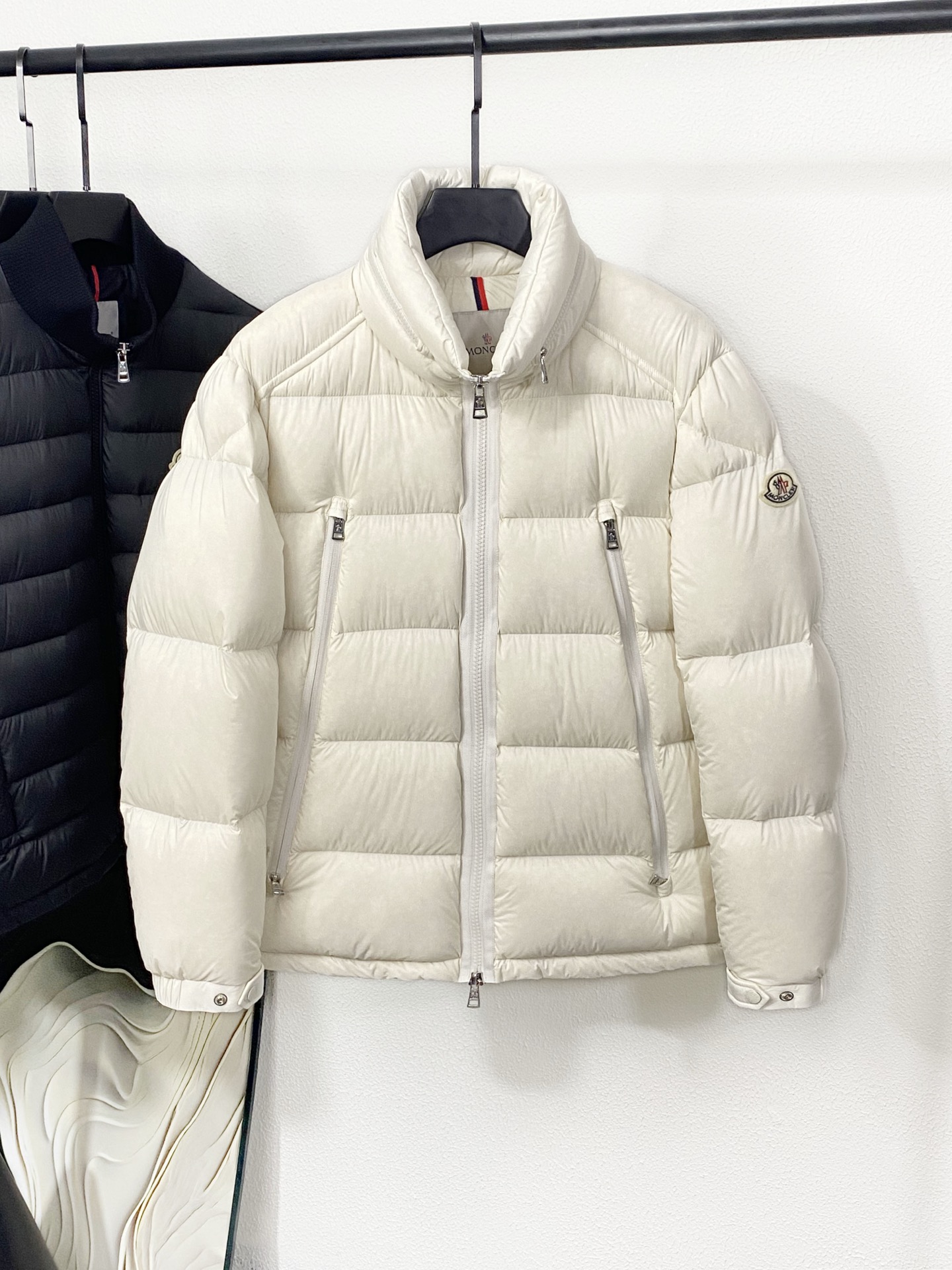 NO:611460,(New product (MON25FW new lightweight nylon down jacket for autumn and winter, hidden hooded stand-collar down jacket for men and women! Trading company channels are rare, and it is available on the official website at the same time! The new down jacket from Famenjia combines tradition and innovation, bringing a unique sense of fashion to winter wear! It is not only suitable for daily wear, but also an ideal choice for outdoor activities!  The fabric is made of custom-made light nylon material. This material is not only silky and soft to the touch, but also shiny, which can visually enhance the overall texture and fashion! The interior is filled with 90-down white duck down that meets European standards.  Down has high fluffiness and strong warmth, and can provide enough warmth even in the cold winter! The iconic felt badge on the sleeve arm is one of the brand's classic design elements. It not only increases the layering of the clothing, but also shows the brand's unique charm!  The custom-made hardware accessories such as engraved buttons and metal zippers are of excellent quality, which enhances the overall grade and texture of the product. The processing of these details makes the clothing more refined and durable! At the same time, the concealable hooded stand-up collar design enhances the protection of the clothing, which is both practical and convenient! The casual cut makes the clothing more lightweight and flexible, suitable for various occasions! The design of the same style for men and women also increases the audience range of the product, both men and women can easily wear this down jacket!  Color White, Black Size 1-5 Size Reference Size 1: Shoulder Width 46 Bust 112 Sleeve Length 63 Clothing Length 67 Size 2: Shoulder Width 47 Bust 116 Sleeve Length 64 Clothing Length 68 Size 3: Shoulder Width 48 Bust 120 Sleeve Length 65 Clothing Length 69 Size 4: Shoulder Width 49 Bust 124 Sleeve Length 66 Clothing Length 70  Size 5: shoulder width 50, bust 128, sleeve length 67, dress length 71,,jackets & coats,jackets & coats,down jacket,hats,alexander wang19860909(新品(MON25FW秋冬新款轻薄尼龙羽绒夹克,男女同款隐藏连帽立领羽绒服外套！贸易公司渠道稀出,同步官网发售！法蒙家新款羽绒夹克结合了传统与创新,为冬日穿搭带来了独特的时尚感！它不仅适合日常穿着,还能作为户外活动的理想选择！ 面料采用客供定制的轻薄尼龙材质,这种材质不仅触感丝滑轻柔,还富有光泽感,能够在视觉上提升整体的质感和时尚度！内里填充的是符合欧洲标准的90绒子的白鸭绒,这种羽绒蓬松度高、保暖性强,即使在寒冷的冬季也能提供足够的温暖！袖臂上的标志性毛毡徽章是品牌的经典设计元素之一,它不仅增加了衣物的层次感,还展现了品牌的独特魅力！ 客供定制的刻印纽扣和金属拉链等五金辅料品相极佳,提升了产品的整体档次和质感,这些细节的处理使得衣物更加精致、耐用！同时可隐藏的连帽立领设计增强了衣物的防护性,既实用又方便！休闲版型裁剪,使得衣物更加轻便、灵活,适合多种场合穿着！男女同款的设计也增加了产品的受众范围,无论是男性还是女性都可以轻松驾驭这款羽绒服！ 颜色白色、黑色 尺码1-5 尺寸参考 1码:肩宽46胸围112袖长63衣长67 2码:肩宽47胸围116袖长64衣长68 3码:肩宽48胸围120袖长65衣长69 4码:肩宽49胸围124袖长66衣长70 5码:肩宽50胸围128袖长67衣长71,,jackets & coats,jackets & coats,down jacket,hats,alexander wang,Men's clothing