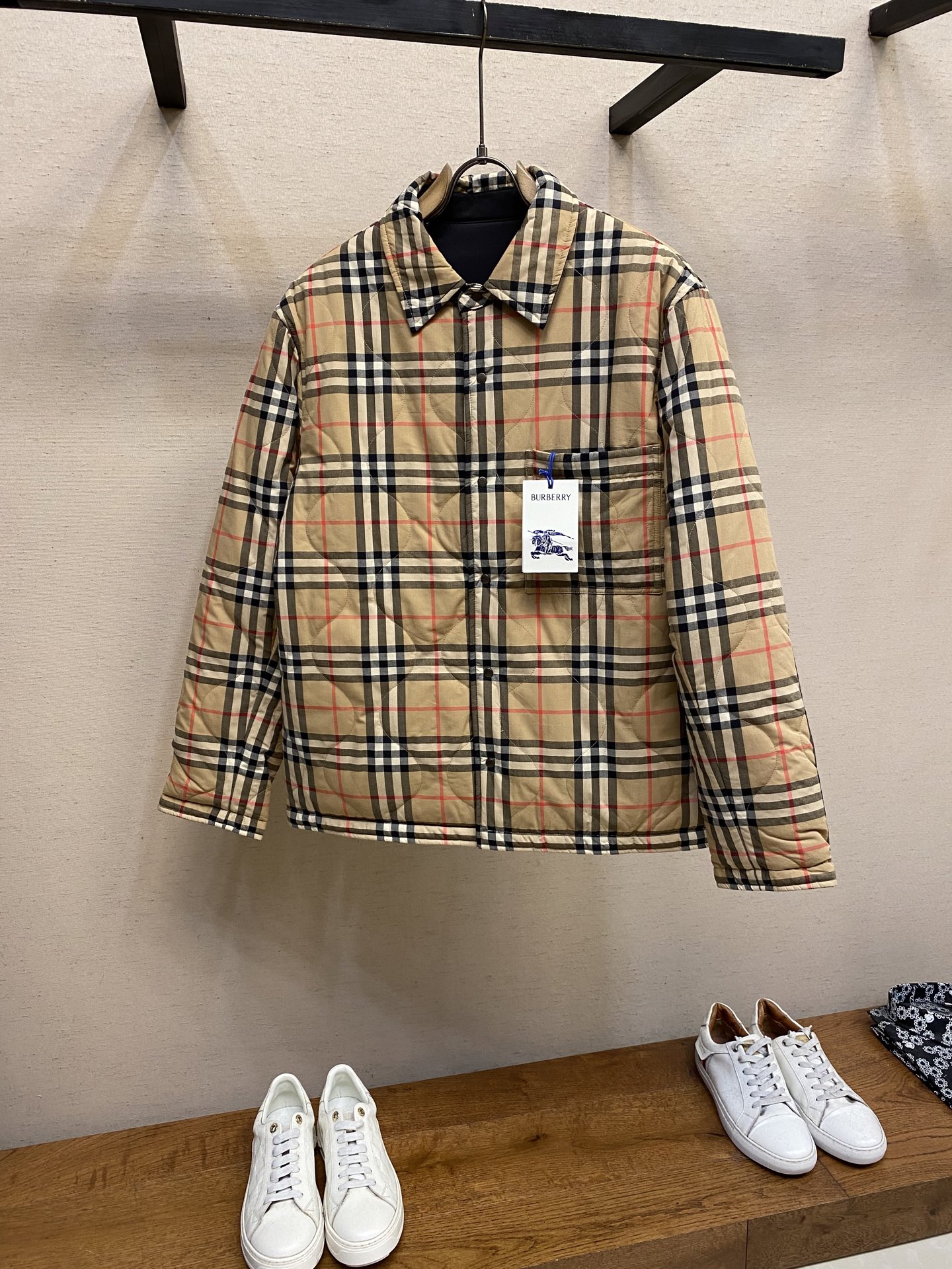 NO:539499,BBR, plaid quilted double-sided cotton clothing Fabric 1 is made of cotton yarn dyed and woven. The cotton fiber is naturally skin-friendly and breathable, and has a high color fastness. The plaid lines form a faint relief effect through the changes in the color and depth of the yarn and the weaving method. The touch is smooth but the visual layer is rich. The pattern is woven into the bones. It is washed repeatedly and does not fade or wear. Fabric 2 is made of polyester fiber. It has extremely high strength and wear resistance, and is also small in density. It is still very light after making the fabric, which reduces the burden on the whole. Process 1  The letter embroidery decorated on the black chest patch pocket is set to a high stitch density through a computer embroidery machine, and the fabric and the base liner are tightly fixed to the frame of the embroidery machine, with uniform tension and just right tension. The double-axis linear guide drives the embroidery frame, and the frame shift accuracy can reach 0.01mm/P, ensuring accurate positioning and clear embroidery pattern. Process 2 Define the wave arc and row spacing through the quilting machine computer system, stack the surface cloth and cotton together, accurately adjust the tension, speed and pins of the machine, and the stitching traces during operation are smooth and uniform, without any sense of pause, and the smooth curves are arranged accurately on the cutting sheet. Process 3 Use positioning and cutting equipment to accurately cut the fabric, and improve the overall quality through optical positioning and mechanical positioning. Each product meets the high standards of alignment and grid alignment. Size S-XL, alexander wang19860909BBR,格纹绗缝双面穿棉服 面料1 选用棉纱线染色之后编织而成,棉纤维具有天然的亲肤性和透气性等,色牢度较高.格纹线条通过纱线色彩与织法的深浅变化,形成若隐若现的浮雕效果,触感平滑却视觉层次丰富,将图案编织入骨,反复水洗不易褪色,磨损. 面料2 选用聚酯纤维编织而成,其具有极高的强度和耐磨性,同时密度较小,制成面料之后仍非常轻盈,给整体减轻负担. 工艺1 黑色面胸贴袋处饰以的字母绣花通过电脑绣花机设置极高的针迹密度,将面料和底衬一同紧绷地固定在绣花机的框架上,张力均匀且恰到好处.双轴直线导轨驱动绣框,移框精度可达0.01mm/P,确保精准定位,刺绣图案清晰. 工艺2 通过绗缝机电脑系统定义波浪弧度以及行列间距,将表布、棉层叠放固定在一起,精确调整机器的张力、速度和针脚,作业中线迹平滑、均匀,没有顿挫感,将流畅的曲线精准的排列在裁片之上. 工艺3 使用定位裁床设备进行精准裁剪布料,通过光学定位和机械定位提高整体质量,每一件产品都符合对位对格的高标准. 尺码S-XL,,alexander wang,Men's clothing