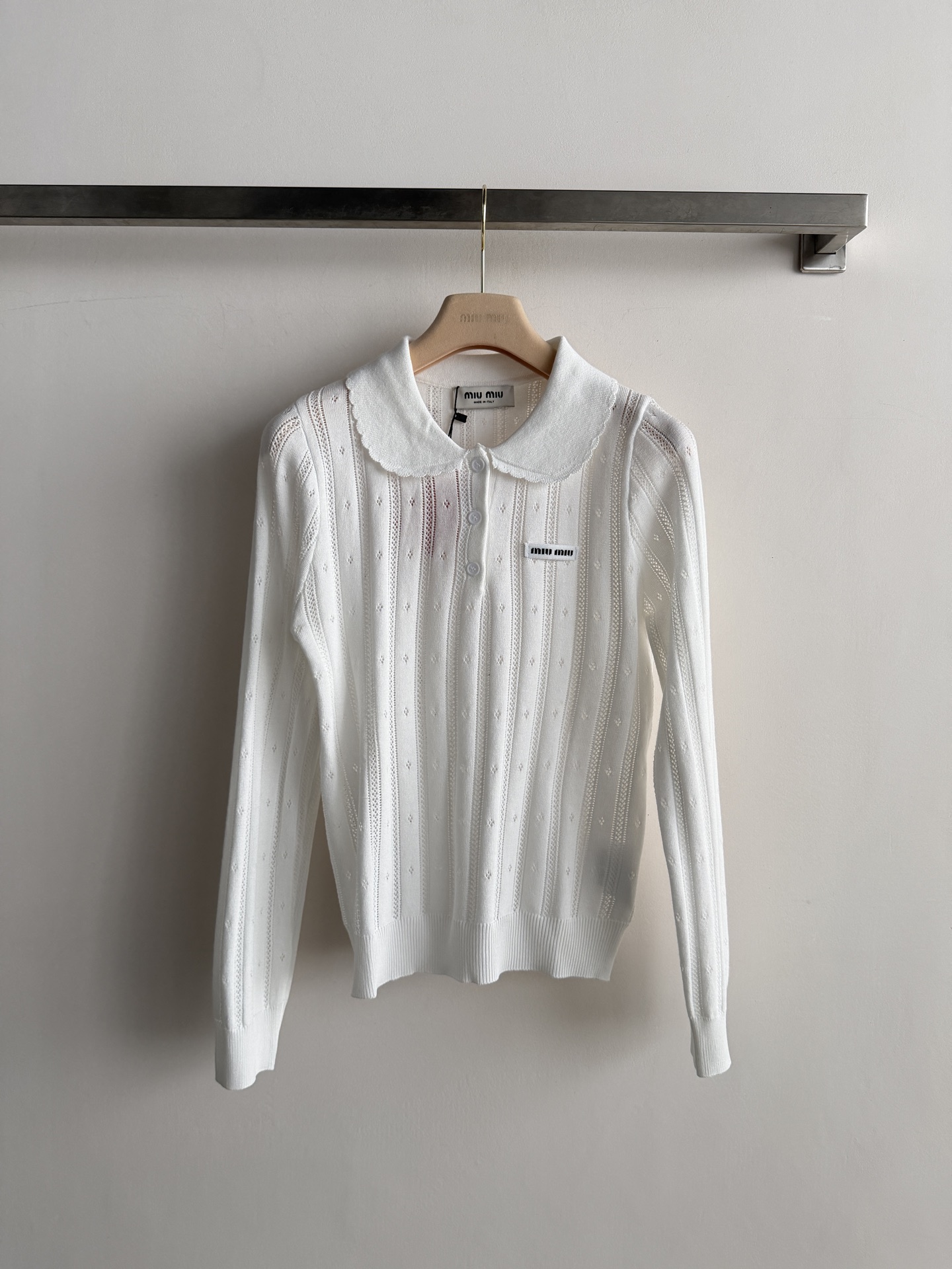 NO:934684,Miu Mi* baby-neck hollow sweater, long-sleeved slim fit, wavy lace on the edge of the lapel, three buttons on the collar placket, and a small Miu Miu logo on the left chest. Vertical stripes hollow pattern all over the body, the fabric is soft and slightly stretchy. The upper body is very comfortable, paired with a pleated skirt and loafers, the most classic Miu  This style is worn with a collegial feel and is perfect for taking photos on the street. Wear it with wide-leg jeans and ballet shoes - it makes you look slimmer and taller, relaxed and textured!  3 colors SML,,miumiu,loafers,skirts,jeans,19860909Miu Mi* 娃娃领镂空针织衫,长袖修身版型,翻领边缘有波浪花边,领口门襟三颗纽扣装饰,左胸有 Miu Miu小标.全身竖条纹镂空花纹,面料柔软微弹.上身很舒适, 搭百褶短裙+乐福鞋最经典的 Miu 系穿法,学院感拉满,出街拍照很出片.搭阔腿牛仔裤+芭蕾鞋——更显瘦显高的方向,松弛又有质感！3色SML,,miumiu,loafers,skirts,jeans,,Women's clothing