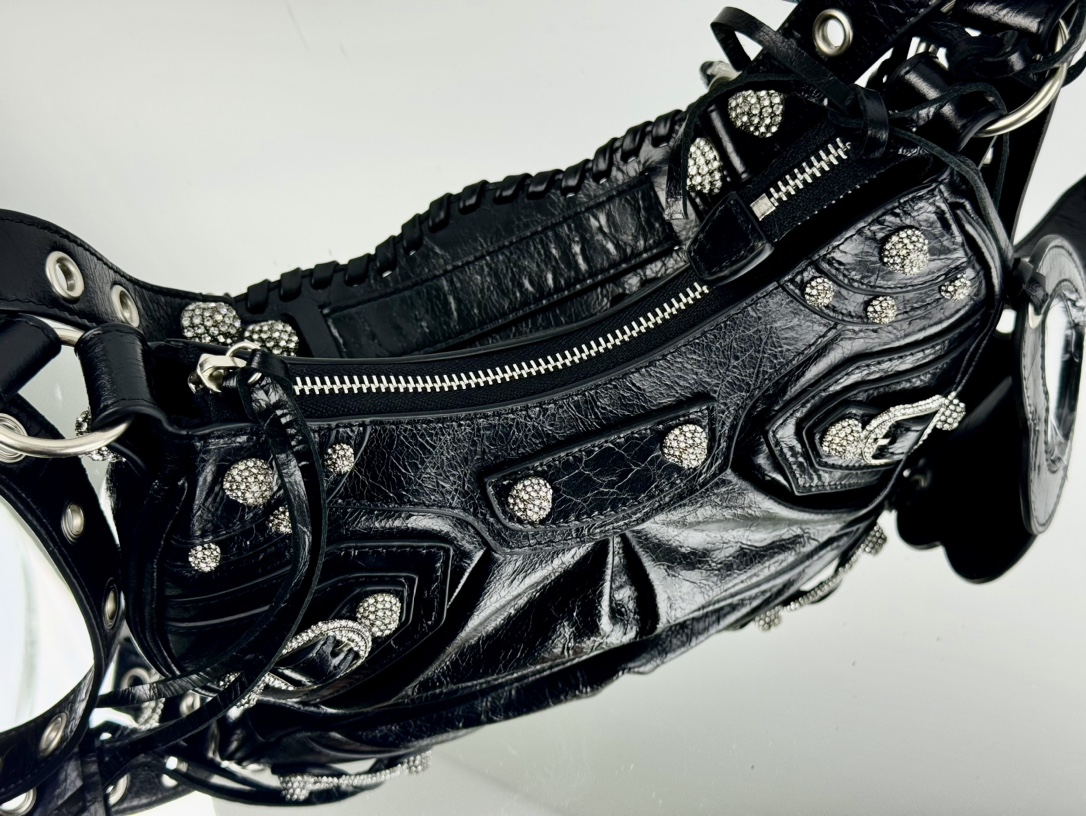 🖤油蜡黑/钻扣🖤出货✔️小号
Balenciag Le Cagole半月牙腋下包饺子包
致敬经典机车包系列重磅新款王炸登场la～在传统的机车包上做了改良 可调节编织肩带附加孔眼和外挂皮革卡包、心型挂镜♡沿用经典机车元素 细节非常讲究 上身简直痴迷
复古率性 充满摇滚气息的大胆与前卫 辣妹本辣必须人手一个 爱了！
款号：701小号
尺寸：长26X高16X宽10CM
