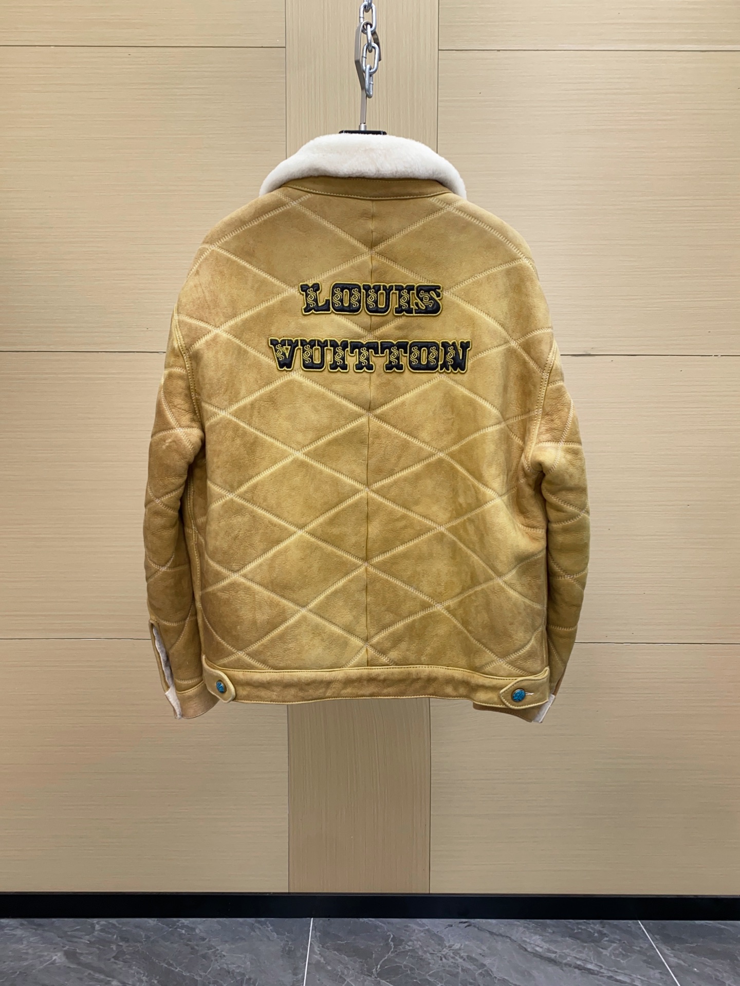 P2760 现货发售！LV 男装刺绣（羊皮毛一体）工装束腰夹克 本款羊毛皮革束腰夹克采用精湛匠艺构筑休闲廓形，以全幅菱格缝线致敬品牌传统硬箱的内衬设计。前后点缀复古加衬刺绣皮革 LV 和路易威登贴饰，点明 2025 秋冬秀场的 Far West 主题，纽扣和铆钉再添考究气息。
休闲版型 正面左侧口袋呈现加衬刺绣 LV 贴饰 后部呈现加衬刺绣路易威登贴饰 羊毛皮革衣领和内里 拉链前襟配有 LV 铭纹拉链头 纽扣和铆钉 尺码：48-56 