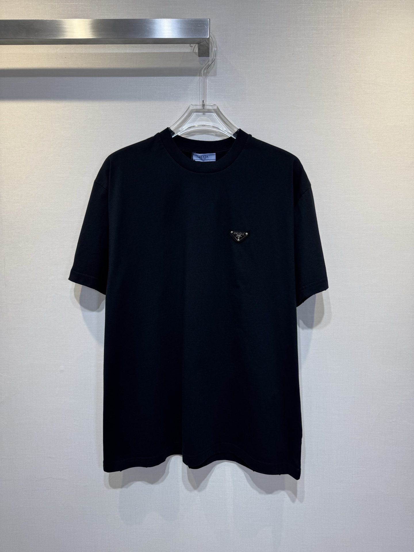 La camiseta con logo triangular PRADA/Metal está confeccionada con tejido de punto de algodón de alta precisión de 32 h…