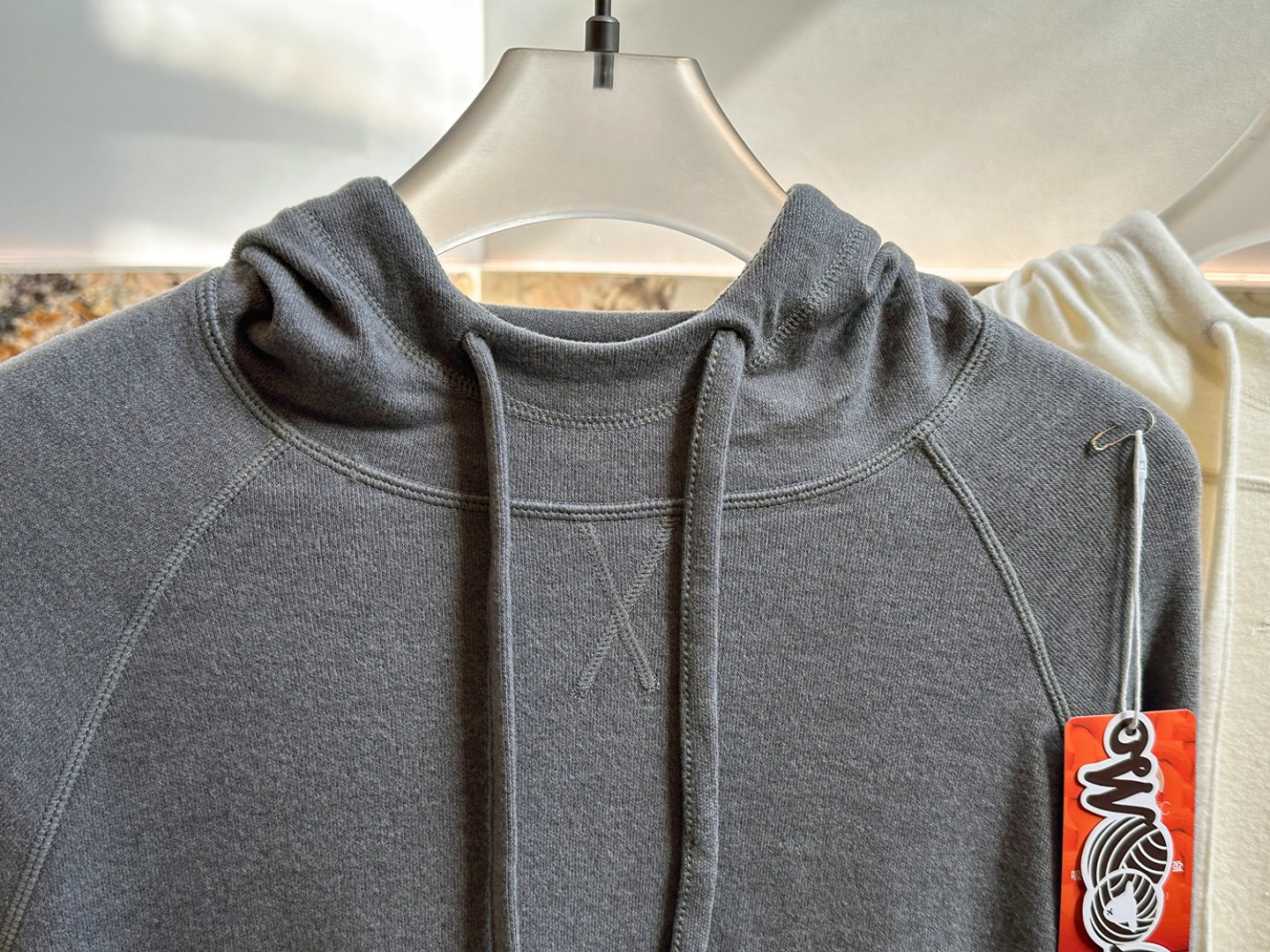 Hooded design that visually softens the shoulder line. - Comprehensive 4