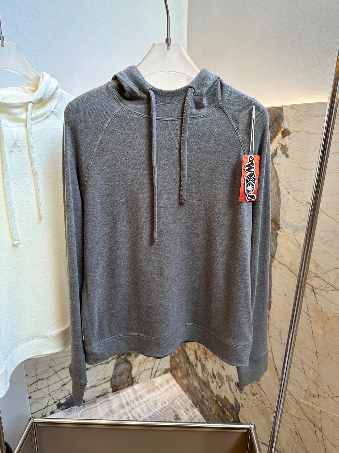 Hooded design that visually softens the shoulder line. - Comprehensive 3