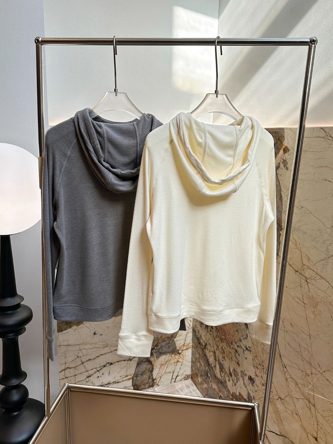 Hooded design that visually softens the shoulder line. - Comprehensive 2