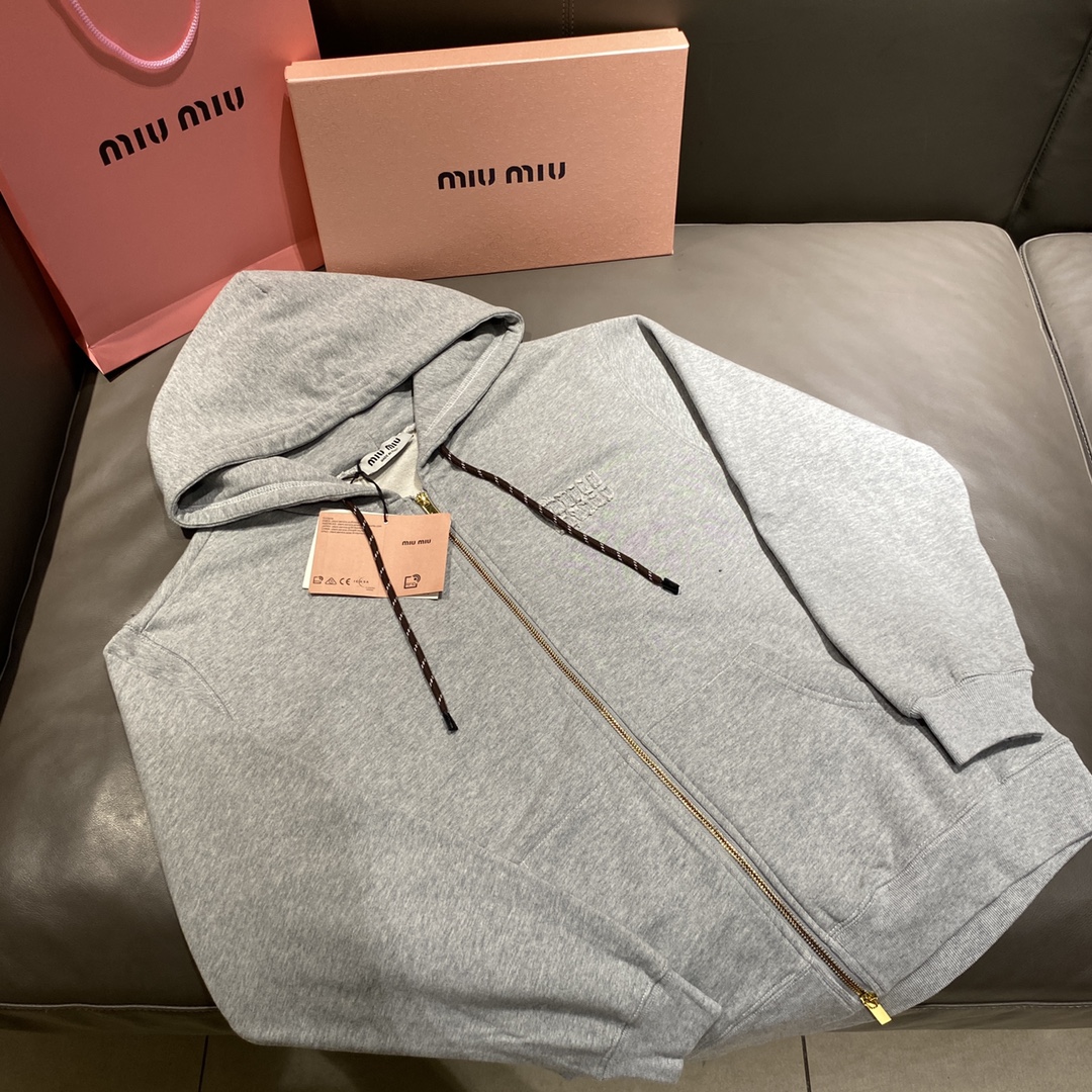 顶版 Miu Miu/缪缪 24Fw 贴布刺绣字母拉链外套 面料采用100%纯棉毛圈面料，克重大约在420g左右，衣物为正肩膀版型，洗后不易变形，胸口定制的是品牌logo的贴布，并且进行了手工撕裂处理。拉链定制的是与原版一致的金色双头拉链…