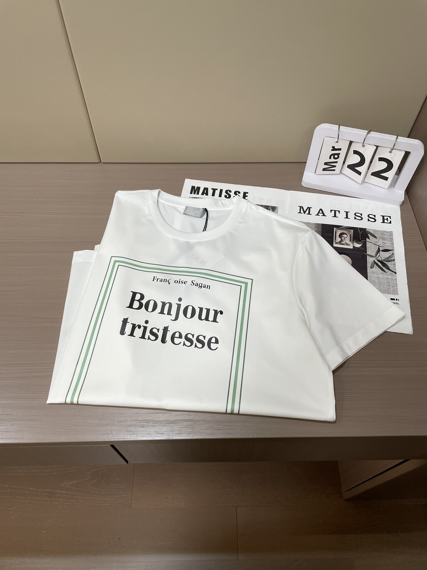 Dior 2026春夏男装系列中的​​文学封面纯色短袖T恤​​，设计灵感源自法国作家弗朗索瓦丝·萨冈（F