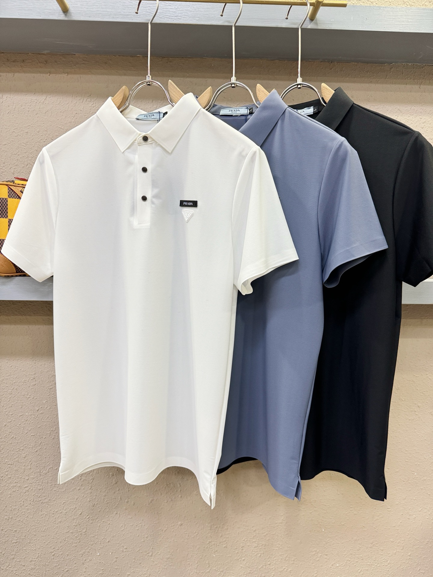 PRADA 普拉达  2026春夏新款首发专柜最新款翻领短袖，冰丝面料，高端订制 设计前卫时尚！品牌logo重工艺设计 