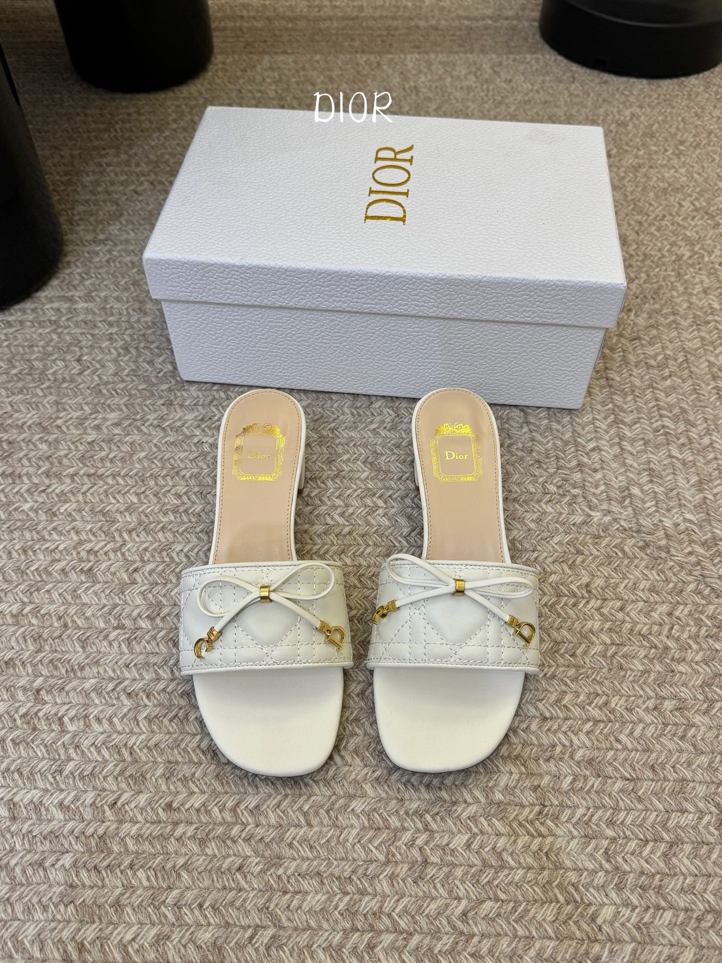 NO:788800,Thick-heeled Dior Cannage cannage electro-embroidered CD bow mules sandals. The quilted upper is made of fine sheep leather. The iconic rhombus texture is embellished with handmade bows and golden D-shaped buckles, integrating the brand's classic elements into the details. The square-toe silhouette is paired with two heel heights. The thick heel model modifies the leg shape, and the flat-soled model is relaxed and casual, suitable for commuting, vacation, and daily life. The upper is imported lambskin/sheepskin lining  Leather outsole size 35-39 (customized 40-43), slippers, dior, dior, slippers, sheepskin, Leather soles19860909粗跟 Dior 迪奥·Cannage 藤格纹电绣CD蝴蝶结穆勒凉拖鞋 精选细腻羊皮革打造绗缝鞋面,标志性菱格纹肌理间点缀手工蝴蝶结与金色D字饰扣,将品牌经典元素融于细节；方头廓形搭配两种跟高可选,粗跟款修饰腿型、平底款松弛随性,适配通勤、度假、日常全场景. 鞋面进口小羊皮/羊皮内里 真皮大底 size35-39（40-43定做）,拖鞋,dior,dior,slippers,sheepskin,Leather soles,Women's Shoes