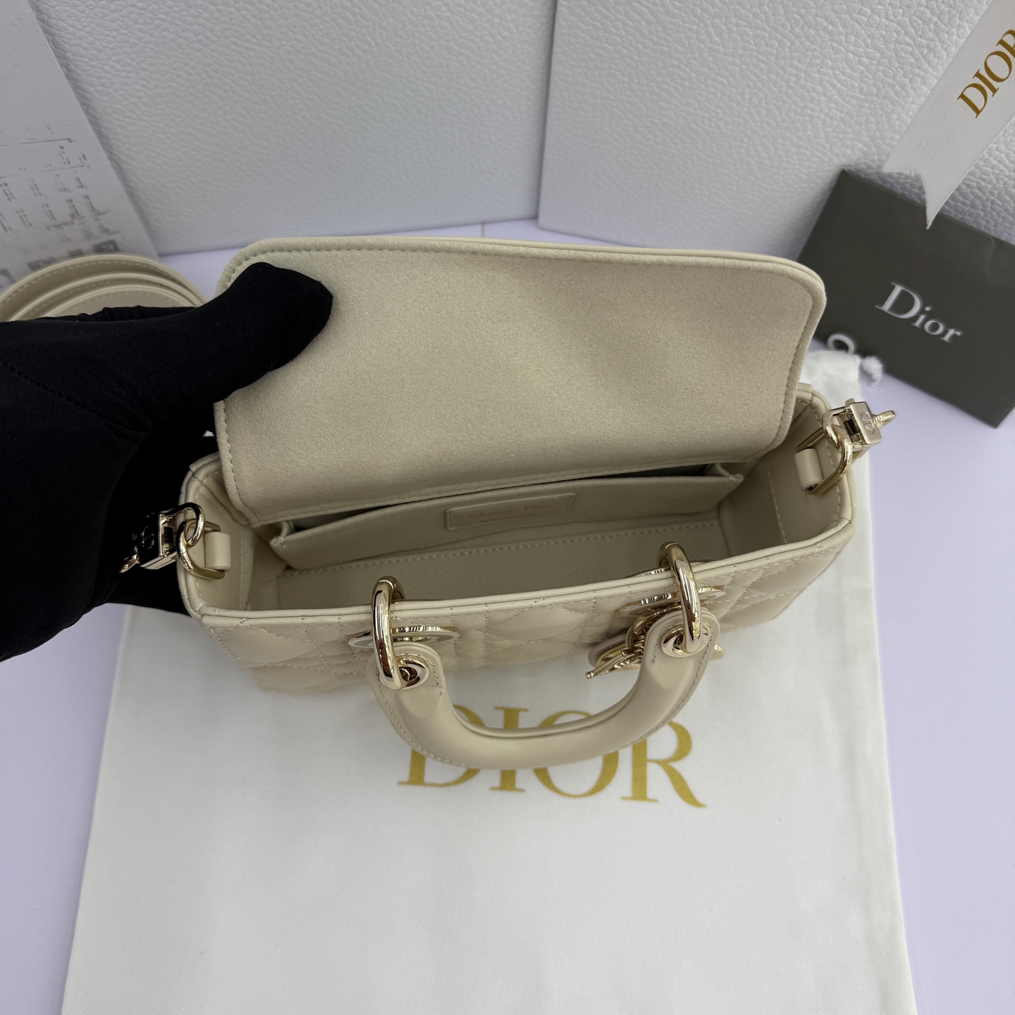 Lady D-Joy 手袋_ 款号：M0636_浅米色
这款 Lady D-Joy 手袋是二零二五秋冬成衣系列新品，凸显 Lady Dior 系列经典的简约美学，集中体现了 Dior 对典雅和美丽的深刻洞见。采用浅米色羊皮革精心制作，饰以藤格纹缉面线，时髦典雅的设计经久不衰。搭配浅金色饰面金属 D.I.O.R 吊饰提升格调，为精美的轮廓增添一分灵动。迷你款式，搭配可拆卸的链条肩带和可调节、可拆卸的皮革肩带，可手提、肩背或斜挎，是日常造型的理想之选。
主体：羊皮革里料:羊皮革可拆卸链条肩带可调节、可拆卸的皮革肩带
内部插袋
内含防尘袋
意大利制造
款号：M0636
尺寸：19&times;10.5&times;5.5厘米（长&times;高&times;宽）
可收纳1部手机、1个卡夹和唇膏
肩带长度：108-118.5 厘米
肩带顶端至手袋顶端长度：51.5-56.5 厘米
链条长度：54.5厘米
链条顶端至手袋顶端长度：24厘米
重量：660克
尺寸和重量详情可能因产品材质有所不同