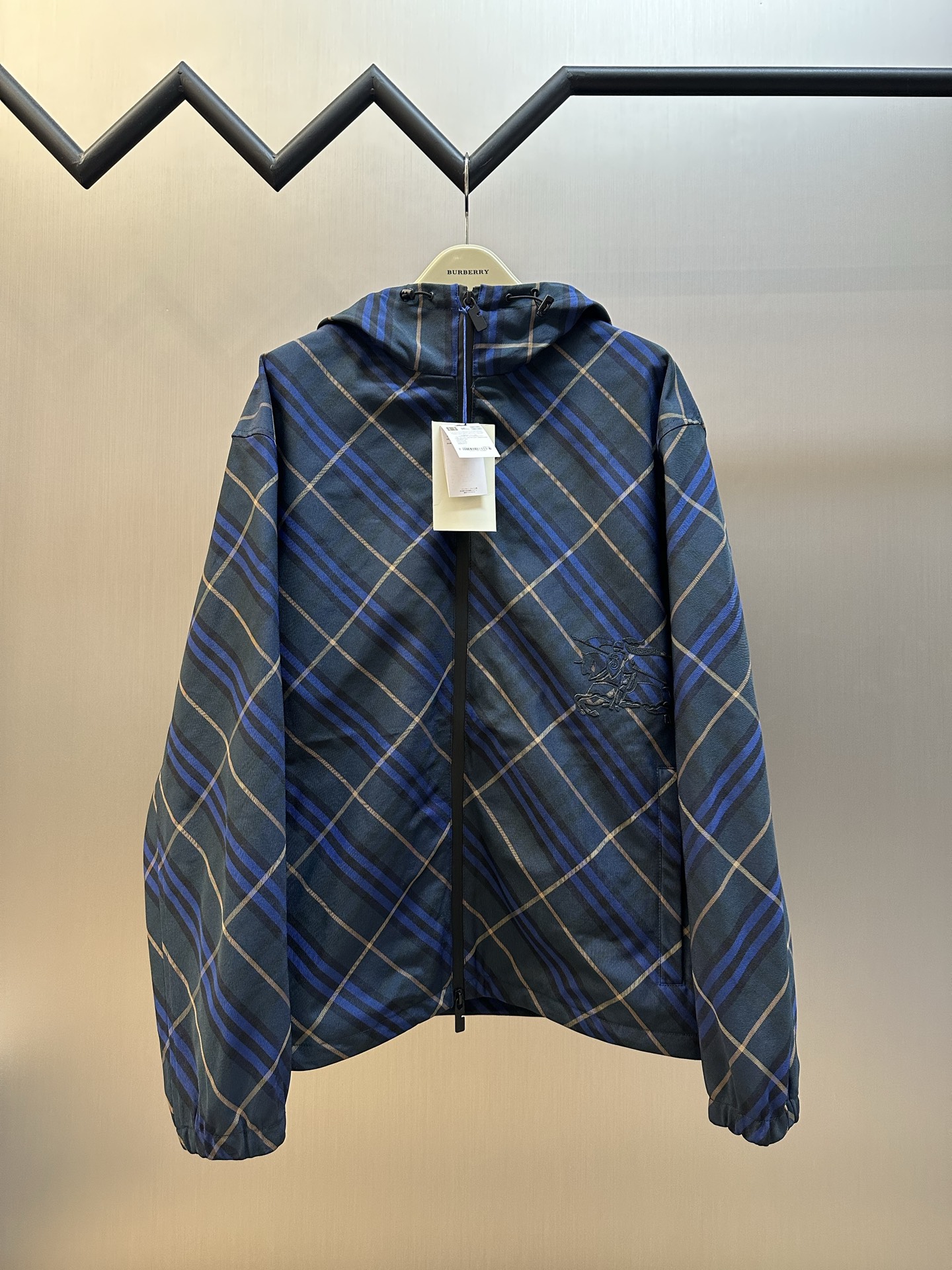 NO:849142,Bbr dark blue twill pattern embroidered jacket is made of high-density woven fabric woven from polyester fiber. It has specific high-strength, anti-wrinkle and quick-drying properties. The high-density weaving method increases its durability and windproofness, has excellent breathability, and has a subtle texture on the surface. The fabric characteristics make the appearance more crisp, the color saturated, and the texture improved.  Use positioning cutting machine equipment to accurately cut fabrics, and improve the overall quality through optical positioning and mechanical positioning. Ensure that each product meets the high standards of alignment. During the sewing process, the master will always ensure that each piece of fabric can be aligned after being linked, which also greatly increases the process time.  The CAD plate making system is used to preset the physical embroidery area and the laser area, and the high-precision war horse embroidery with nearly 9,000 stitches is formed through the 1000rpm needle speed of the embroidery machine. The laser cutting process is then used to accurately remove the base fabric at the embroidery edge area. The laser accuracy of ±0.1mm makes the embroidery smooth and without burrs. sizeM-3XL,,jackets & coats,19860909Bbr 深蓝色斜格纹饰刺绣夹克 选用聚酯纤维编织而成的高密度梭织面料.其本身具体高强度,抗皱和快干的特性,高密织法增加其耐用性和防风性,透气性俱佳,表面呈现细微的纹理.面料特性使外观更挺括,色彩饱和,提升质感. 使用定位裁床设备进行精准裁剪布料,通过光学定位和机械定位提高整体质量.确保每一件产品都符合对位对格的高标准.缝纫过程中,师傅会时刻保证每一片面料链接之后能对位对格,这样也大大增加了工序时长. 采用CAD制版系统预设实体绣区域和激光区域,通过绣花机1000rpm针速形成近9000针的高精度战马刺绣.再使用激光切割工艺,在绣花边缘区域精准移除底布面料,±0.1mm的激光精度使绣体平滑无毛边. sizeM-3XL,,jackets & coats,,Men's clothing
