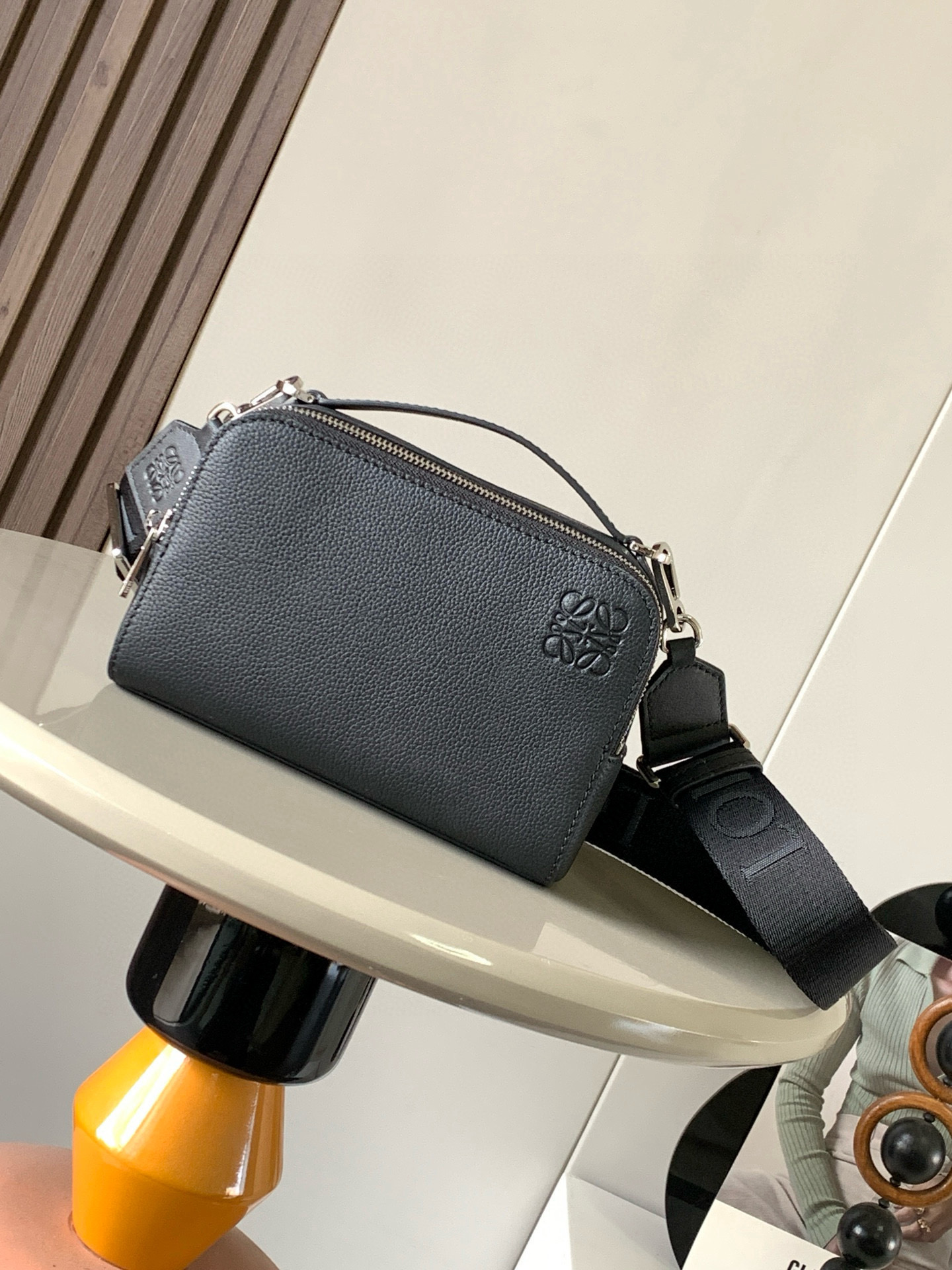 NO:212555,Satin cowhide leather mini camera crossbody bag meets your multifunctional needs. This mini camera bag is made of satin cowhide leather and is smooth in texture, showing the high-quality mini camera crossbody bag design is compact and practical, with two zipper compartments to facilitate storage of cameras and other small objects, whether for travel or daily use, and can meet your needs. At the same time, the removable shoulder strap and top handle design can allow you to choose a crossbody or carry method according to your needs. Flexible carrying is not only practical, but also a beautiful combination of personality and taste. Size 18CM~13CM~8.5CM  Model number 9111 Color black lily, Luo Yiwei, loewe, satchels, crossbody bags, cowhide19860909缎面牛皮革迷你相机斜挎包 满足你的多功能需求,这款迷你相机包采用缎面牛皮革制成质感柔滑,展现出高级品质迷你相机斜挎包设计紧凑实用,设有两个拉链隔层,方便存放相机和其他小物件无论是旅行还是日常使用,都能满足你的需求同时,可调整可拆卸肩带和顶部提手设计,让你可以根据需要选择斜挎或手提方式,灵活携带除了实用性,这款相机包还注重细节.插袋设计方便存放小物件人字纹棉质帆布衬里保护相机免受刮擦.Anagram压纹贴片作为品牌标志,为相机包增添了一丝奢华感不仅是一款实用的摄影配件,更是一件时尚的潮流单品让它成为你的时尚标志,展现个性与品味的完美结合 尺寸18CM~13CM~8.5CM 款号9111 颜色黑色荔,罗意威,loewe,satchels,crossbody bags,cowhide,Bag