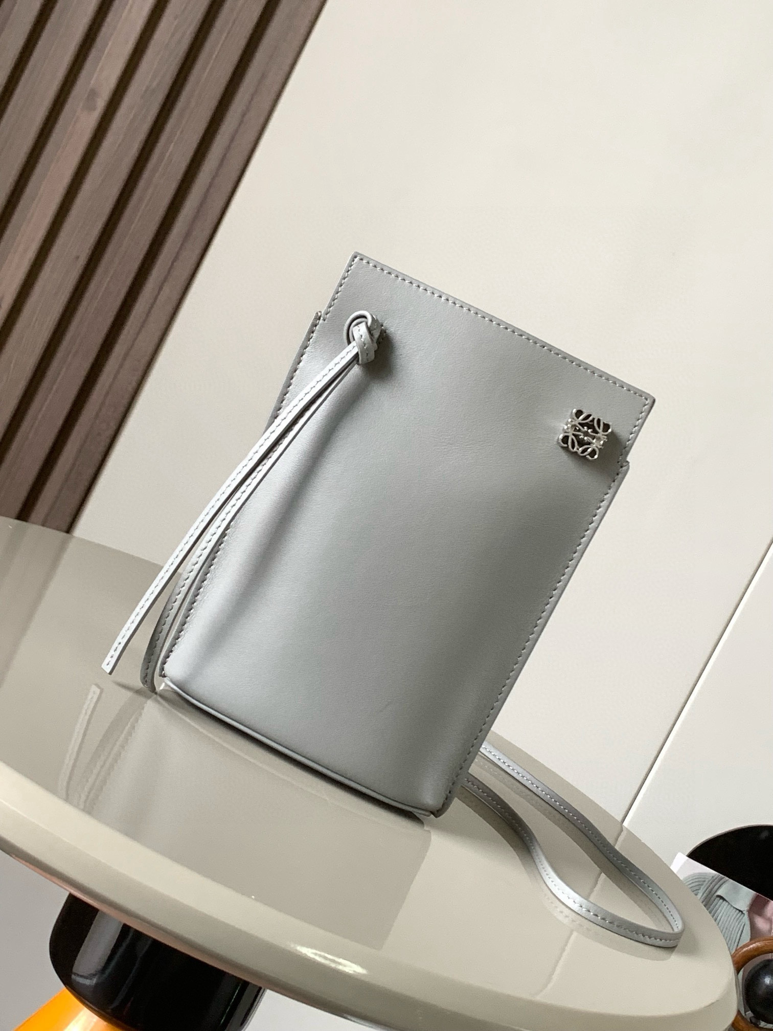 NO:383770,Dice pocket cowhide dice mobile phone bag imported from the original Napa calf leather practical bag is equipped with shoulder straps and Anagram three-dimensional logo. It can be shoulder-mounted or cross-body, with two leather straps. It can be added with personalized dice decoration. The base is embossed with L0EWE steel stamp. The overall simple and generous leather is hard and not easy to deform. The top layer of cowhide is delicate and shiny. The whole bag is made of full-head layer of cowhide material, with a stylist, stylish three-dimensional gold metal logo, and the decoration is low-key and luxurious. The capacity inside is quite large. It can be equipped with a large screen mobile phone with a large screen, lipstick. Size 20.5~13~4.5CM. Model number 9027. Color pearl gray, Luo Yiwei, loewe, cowhide19860909dice pocket牛皮骰子手机包原厂进口纳帕小牛皮实用小包配有肩带和Anagram立体Logo可肩背或斜挎,带有两条皮革带子,可添加个性化骰子装饰串珠底座上带有L0EWE钢印压纹,整体简约大方皮质是偏硬的,不容易变形,头层牛皮,皮质细腻有光泽,整个包包都是全头层牛皮材质包身硬挺有型立体金色金属logo装饰低调奢华,里面的容量还挺大的,可以装大屏手机的大屏手机,口红 尺寸20.5～13～4.5CM 款号9027 颜色珍珠灰,罗意威,loewe,cowhide,Bag