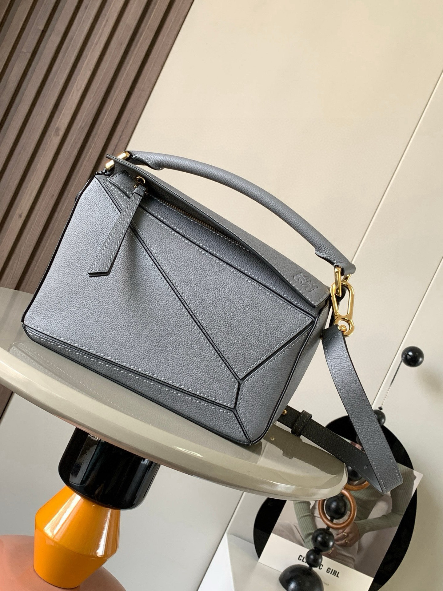 NO:394751,Geometric bag 24CMPuzzle handbags imported from original calfskin plain paper Luojia's popular geometric bag Puzzle handbag is the first handbag launched by creative director Jonathan Anderson. The rectangular shape and precise cutting technology have created Puzzle's unique geometric lines. This small-size version is made of soft grain cowhide leather. Small Puzzle can accommodate for example a large wallet, mobile phones of all sizes and sunglasses with oblique, shoulders, hand holds or top handles. Removable size 24CM~16CM~10CM Model number 9005 Color gray, Loewe, loewe, wallets, cowhide19860909几何包24CMPuzzle手袋原厂进口小牛皮平纹 罗家爆款几何包Puzzle 手袋是创意总监乔纳森·安德森（ Jonathan Anderson）推出的首款手提包长方体形状和精确的切割技术创造了 Puzzle 独特的几何线条这个小尺寸版本采用柔软粒面牛皮革制成＊小号 Puzzle 可以容纳例如一只大号钱包、所有尺寸的手机和太阳镜斜、肩背、手拿或顶部提手携带＊可拆卸 尺寸24CM～16CM～10CM 款号9005 颜色全荔灰色,罗意威,loewe,loewe,wallets,cowhide,Bag