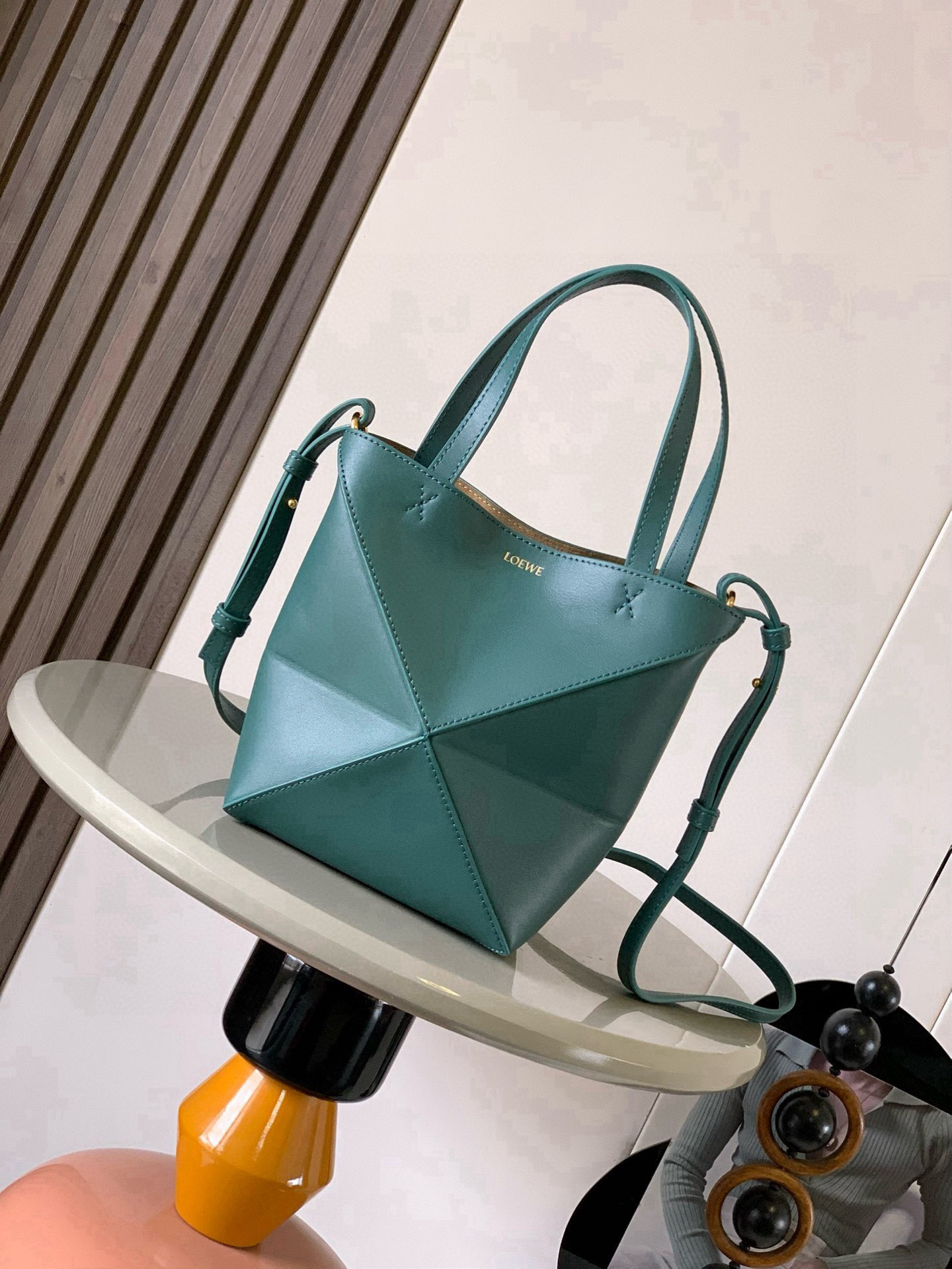 NO:556384,The new glossy cow leather mini puzzle Fold handbag plays with geometric patterns again. It has been a long time since I have seen such a practical and design tote bag. This one continues the geometric aesthetics of the Puzzle series. Inspired by the origami bag, this Puzzle Fold tote can switch between three-dimensional and flat surfaces at will. The leather is very delicate and shiny. It is ultra-light in weight, and the Puzzle can be folded.  The Fold handbag draws inspiration from the geometric lines of the brand's classic handbag series and uses creative ingenuity to reinterpret it into a fashionable tote bag that can be completely folded and is a good travel companion. This mini version is made of soft glossy cowhide. Size 20CM～16.5CM～9CM. Style No. 9030. Color: Aden green, Loewe, loewe, totes, cowhide19860909新款亮面牛皮革迷你号puzzle Fold手袋又把几何图形玩出花了很久没见过这么实用又设计感满满的托特包了这款延续了Puzzle系列的几何美学以折纸包为灵感,让这只 Puzzle Fold tote 在立体和平面随意切换皮质都很细腻光泽本身自重超轻,外加可以折叠Puzzle Fold手袋从品牌经典手袋系列的几何线条汲取灵感运用创意巧思将其重新诠释为一款时尚的托特袋,能完全折叠是旅行良伴.这个迷你号版本采用柔软的亮面牛皮革打造 尺寸20CM～16.5CM～9CM 款号9030 颜色亚丁绿,罗意威,loewe,totes,cowhide,Bag