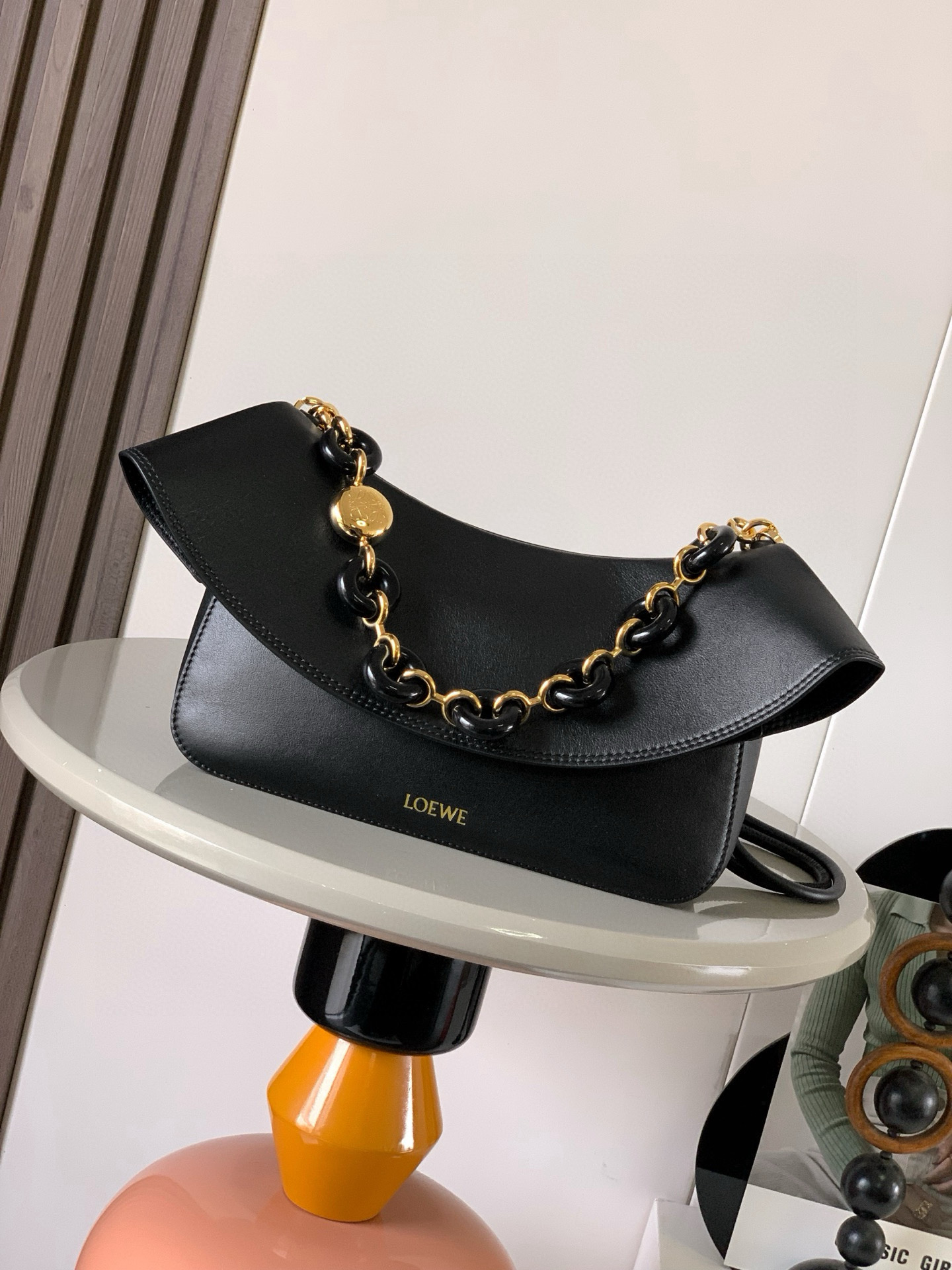 NO:582121,Medium Smooth Cow Leather Ola Handbag Ola is a soft, lightweight, flexible and versatile summer handbag with a curved body, a smooth-line flap and a striking donut chain. This medium version is made of smooth cow leather * Detachable cow leather tubular shoulder strap Detachable donut chain * Flap closure * One inner pocket L0EWE Hot stamping, engraved Anagram logo Size 26CM ~ 18CM ~ 13CM Style No. 9150  Color black,loewe,loewe,cowhide19860909中号光滑牛皮革 Ola 手袋Ola 是柔软轻便且灵活百搭的夏日手袋采用弧形主体、线条流畅的翻盖和醒目甜甜圈链条此中号版本采用光滑牛皮革制成*可拆卸牛皮革管状肩带可拆卸甜甜圈链条*翻盖开合*一个内袋 L0EWE 烫金,镌刻 Anagram 标志 尺寸26CM～18CM～13CM 款号9150 颜色黑色,罗意威,loewe,cowhide,Bag