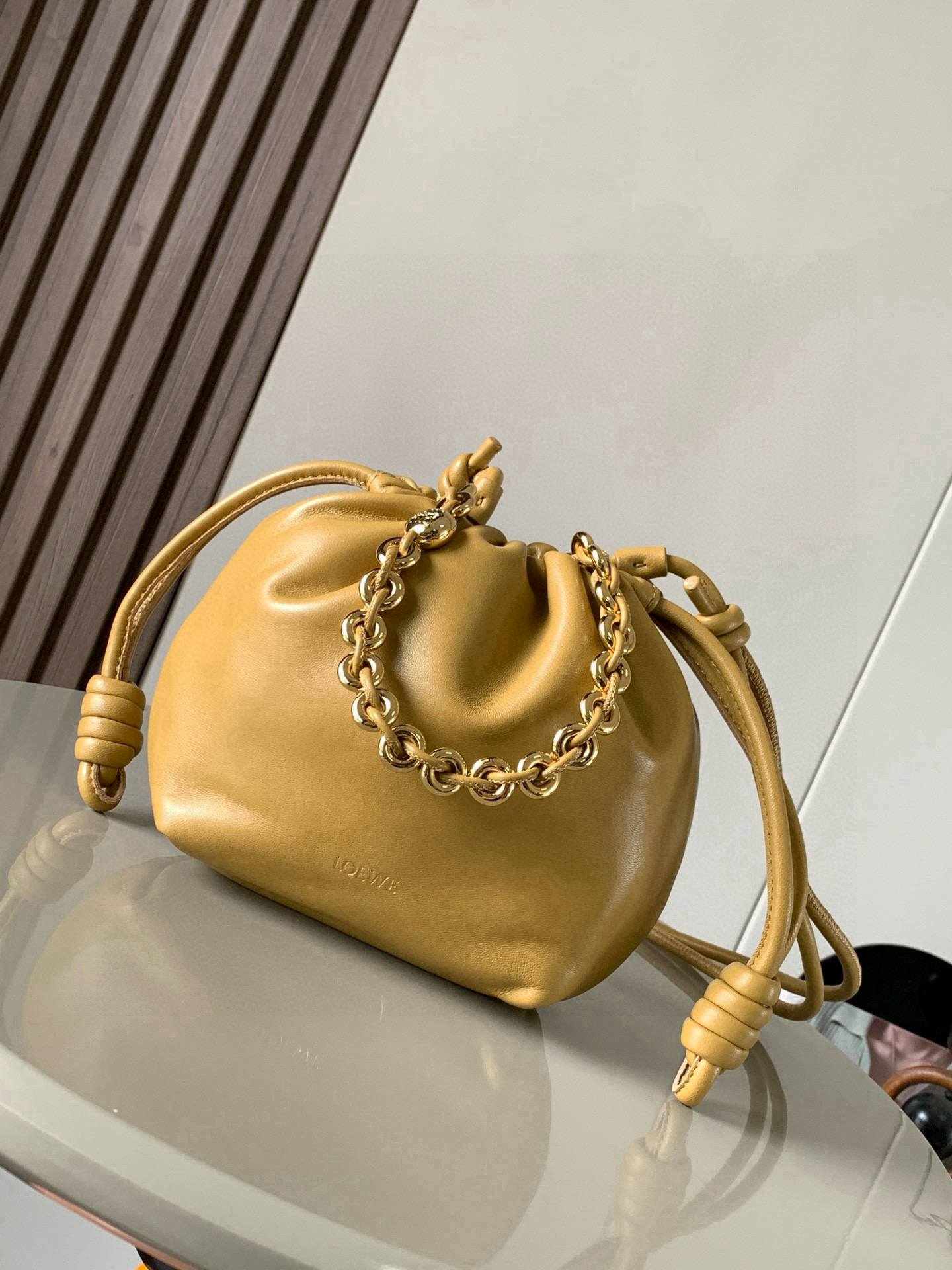 NO:582816,[Celebrity Style] Mini Nappa Lamb Leather Flamenco Purse New Clutch Flamenco Purse handbag features pleated design on the side with key details such as the iconic rope knot. The style is fashionable and versatile and can be carried as a clutch bag, or can be worn on the shoulder with a donut chain or worn cross-body with a leather shoulder strap. This version is made of soft nappa sheep leather. * Can be carried on the shoulder, cross-body or handheld * Detachable and adjustable leather shoulder strap * Detachable donut chain decorated with Anagram  Engraved pebble pattern＊Low-key magnetic buckle closure＊Suede lining＊LOEWE hot stamping or hot silver Style No. 9058 Size 23cm～17cm～5.5cm Color warm sandy yellow, Loewe, loewe, loewe, handbag, sheepskin19860909【明星同款】迷你纳帕羊皮革 Flamenco Purse 新款手拿包Flamenco Purse 手袋采用褶皱设计侧面搭配标志性绳结等关键细节.款式时尚百搭可作为手拿包携带,亦可搭配甜甜圈链条肩背或搭配皮革肩带斜挎.此版本采用柔软纳帕羊皮革制成.＊可肩背、斜挎或手提＊可拆卸可调节皮革肩带＊可拆卸甜甜圈链条饰有 Anagram 镌刻卵石纹＊低调的磁扣开合＊绒面革衬里＊ LOEWE 烫金或烫银 款号9058 尺寸23cm～17cm～5.5cm 颜色暖沙黄,罗意威,loewe,loewe,handbag,sheepskin,Bag