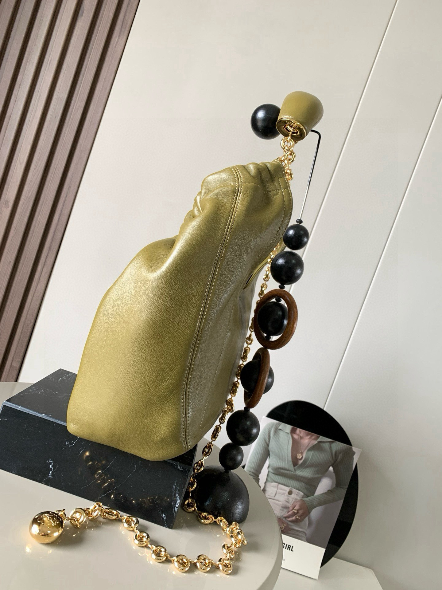 p980。🔥【明星同款】小号纳帕羊皮革Squeeze手袋💄是款精致而柔美的全新手袋💥全新发布的 Squeeze 手袋采用柔软丝滑的Mellow纳帕小羊皮制作而成❤️无衬里结构有效减轻包身自重🌺观感上也更为轻盈⭐️弯月形包口以优雅的褶边收口，营造出轻松又随性的态度👜这款包包还有一大亮点是符合人体工程学的 Squeeze 气囊手柄🌼搭配黄铜打造的精美甜甜圈链条😘可通过链环调节长短或添加延长链，实现手拎、肩背、斜挎等不同背法😻气囊手柄可自由滑动位置以提升舒适度🌻链条底部点缀一枚 Anagram Pebble 吊坠，为包包增添灵动细节⚡️
尺寸：29CM～24CM～10.5CM
款号：9042
颜色：橄榄绿