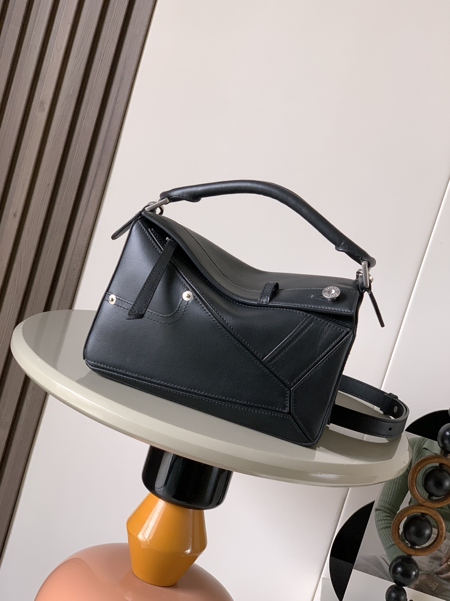 NO:659387,Small glossy cow leather Panta Puzzle handbag Puzzle uses unique geometric lines to outline a rectangular shape. This small version is made of glossy cowhide and decorated with denim trousers style details. Geometric bag 24CMPuzzle handbag imported calfskin plain texture Luojia's popular geometric bag Puzzle handbag is creative director Jonathan Anderson (Jonathan Anderson) for L0EWE  The first handbag launched, the rectangular shape and precise cutting techniques create the unique geometric lines of the Puzzle. This small version is made from soft grained cow leather.  Color black,loewe,loewe,loewe,wallets,cowhide19860909小号亮面牛皮革 Panta Puzzle 手袋Puzzle 以别具一格的几何线条勾勒长方体造型此小号版本采用亮面牛皮革制成,饰有单宁布长裤风格细节.几何包24CMPuzzle手袋原厂进口小牛皮平纹 罗家爆款几何包Puzzle 手袋是创意总监乔纳森·安德森（ Jonathan Anderson）为 L0EWE 推出的首款手提包长方体形状和精确的切割技术创造了 Puzzle 独特的几何线条这个小尺寸版本采用柔软粒面牛皮革制成＊小号 Puzzle 可以容纳例如一只大号钱包、所有尺寸的手机和太阳镜斜、肩背、手拿或顶部提手携带＊可拆卸 尺寸24CM～16CM～10CM 款号9109 颜色黑色,罗意威,loewe,loewe,wallets,cowhide,Bag