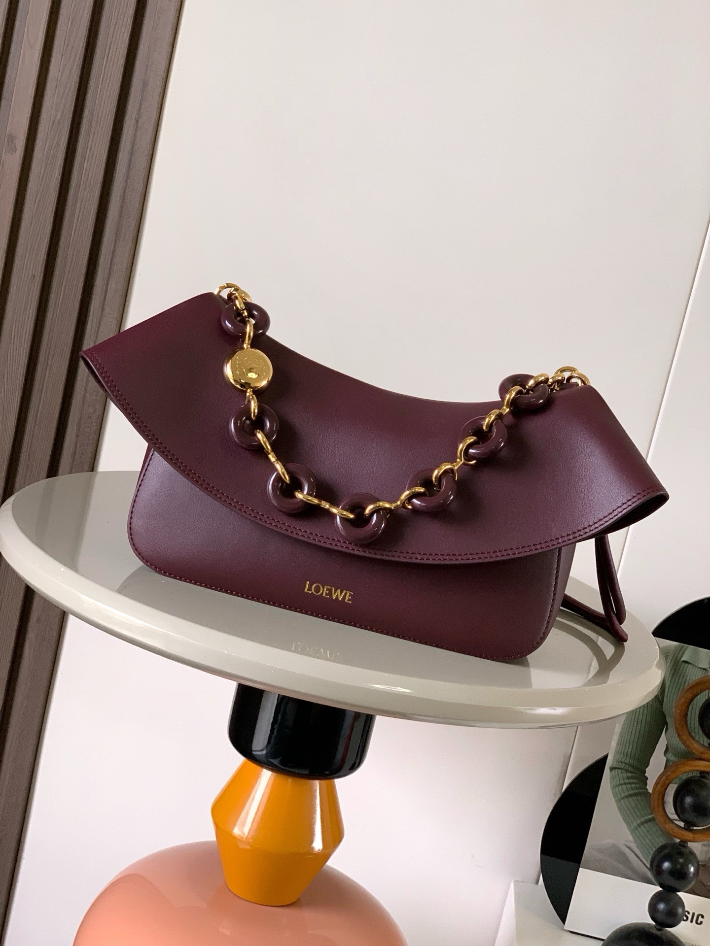 NO:895391,Medium Smooth Cow Leather Ola Handbag Ola is a soft, lightweight, flexible and versatile summer handbag with a curved body, a smooth-line flap and a striking donut chain. This medium version is made of smooth cow leather * Detachable cow leather tubular shoulder strap Detachable donut chain * Flap closure * One inner pocket L0EWE Hot stamping, engraved Anagram logo Size 26CM ~ 18CM ~ 13CM Style No. 9150  Color burgundy,loewe,loewe,cowhide19860909中号光滑牛皮革 Ola 手袋Ola 是柔软轻便且灵活百搭的夏日手袋采用弧形主体、线条流畅的翻盖和醒目甜甜圈链条此中号版本采用光滑牛皮革制成*可拆卸牛皮革管状肩带可拆卸甜甜圈链条*翻盖开合*一个内袋 L0EWE 烫金,镌刻 Anagram 标志 尺寸26CM～18CM～13CM 款号9150 颜色勃艮第红,罗意威,loewe,cowhide,Bag